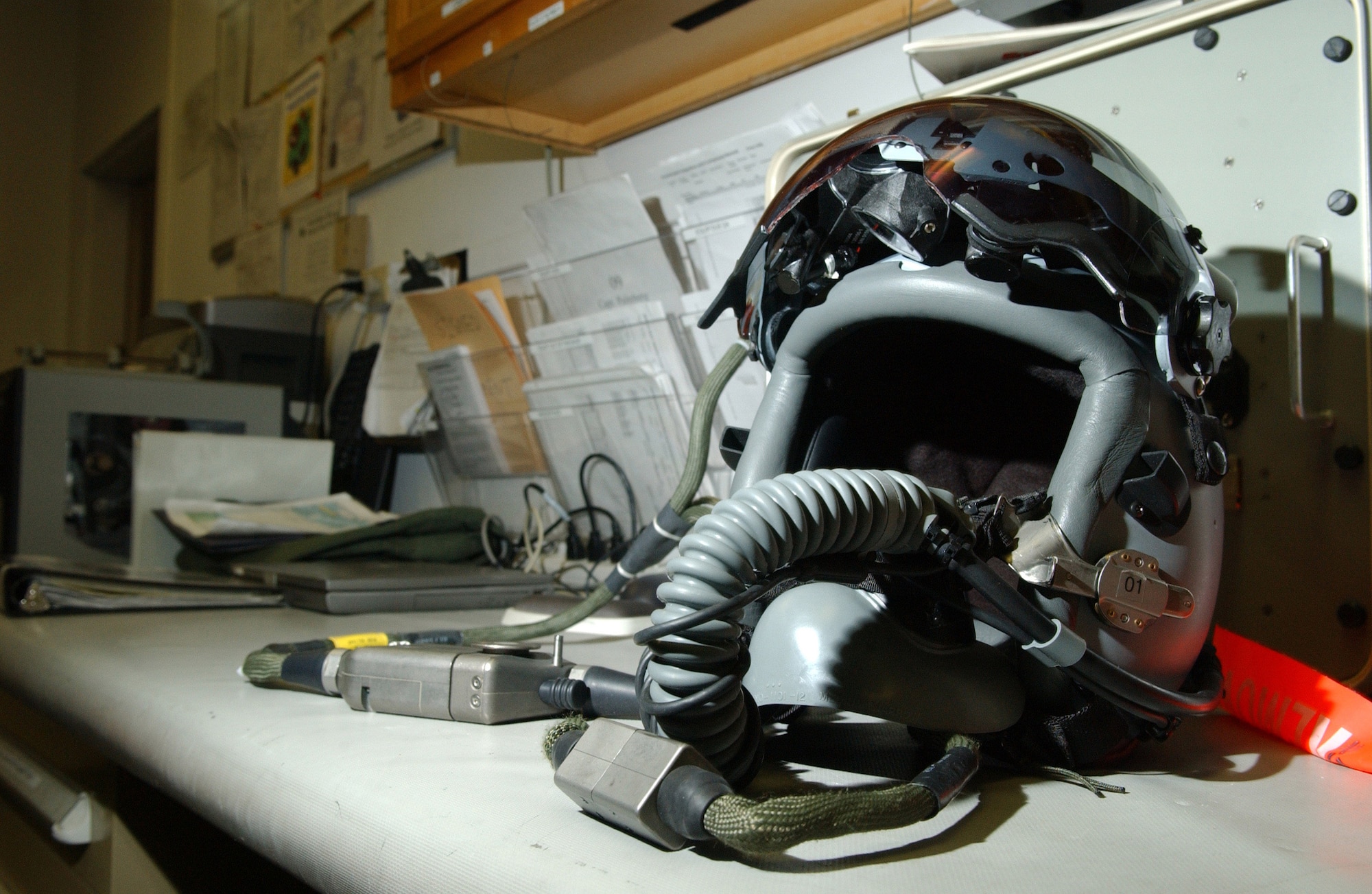 A newly improved fighter pilot helmet with a mounted video camera sits Feb. 21 at the 18th Fighter Squadron at Eielson Air Force Base, Alaska. The new helmet mounted queing system has targeting technology that projects holographic data on the inside right of the visor in the form of a container, or que and allows pilots to continually survey and distinguish between friendly and enemy air and ground targets. (U.S. Air Force photo/Airman 1st Class Christopher Griffin) 
