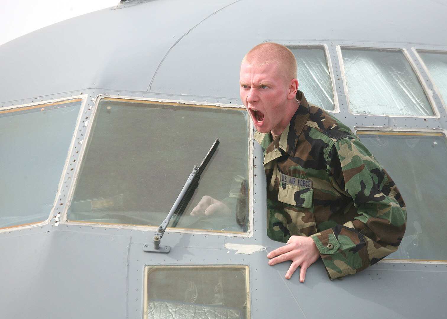 "Hijacker" Airman Joel Vail, 342nd Training Squadron, yells his demands during a training exercise conducted Feb. 26 by the 37th Training Wing at Lackland Air Force Base, Texas. The wing conducted the mock drill to test and evaluate its ability to respond to a major incident that included reports of explosions and gunfire heard at the Lackland Training Annex. Another scenario involved the hijacking of a C-130 at the Kelly Annex. (USAF photo by Robbin Cresswell)
