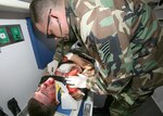Airman M Tyler Smith, 342nd Training Squadron, receives medical aid by Tech Sgt. Damian Merrill, 959th Medical Surgical Operations Squadron, during a training exercise conducted Feb. 26 at Lackland Air Force Base, Texas. The 37th Training Wing conducted the mock drill to test and evaluate its ability to respond to a major incident. The major incident included reports of explosions and gunfire heard at the Lackland Training Annex. A scenario also involved a hijacking of a C-130 at the Kelly Annex. (USAF photo by Robbin Cresswell)