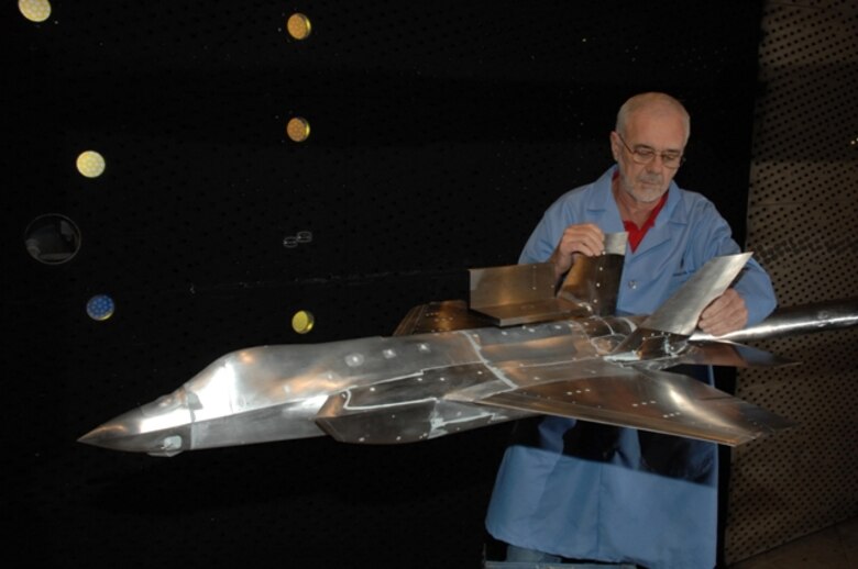 Aerospace Testing Alliance Outside Machinist Carey Wofford checks the movement of the vertical stabilizers of an F-35 Lightning II test article at Arnold Engineering Development Center, Arnold Air Force Base, Tenn., during a model change prior to resuming an aerodynamics test. (Air Force photo Rick Goodfriend)