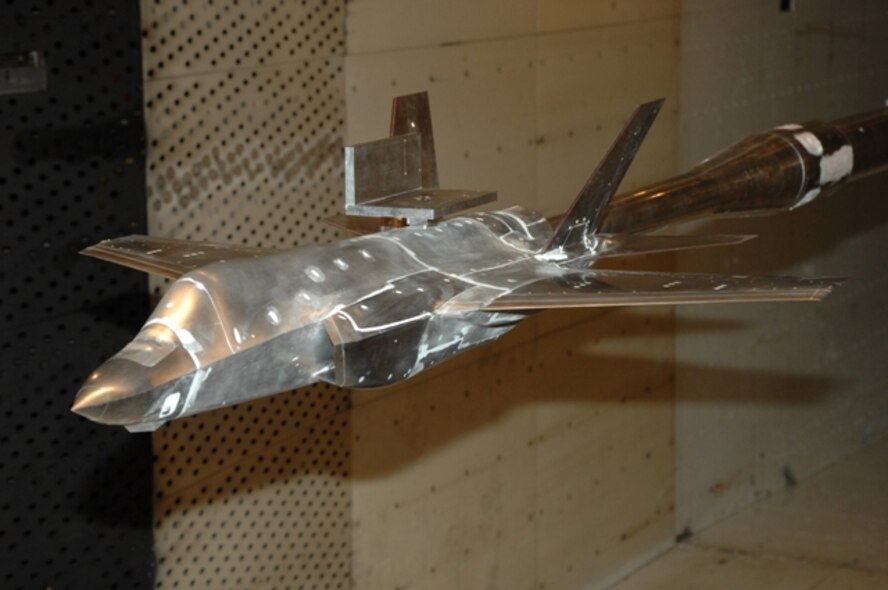 The "level plate," mounted in front of the vertical stabilizers on this F-35C 1/12th scale wind tunnel model, is installed during configuration changes to mount external instrumentation used to verify the model pitch and roll position during testing here at Arnold Engineering Development Center, Arnold Air Force Base, Tenn. (Photo by Rick Goodfriend)
