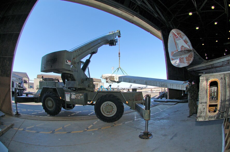 DOVER AIR FORCE BASE, Del. -- A crew of Royal Air Force air frame technicians on temporary duty here use a crane to prepare a set of C-130 wings for airlift aboard an Air Force C-5 to the United Kingdom recently. The wings were airlifted Feb. 23 aboard a WrightPatterson Air Force Base, Ohio, C-5. The wings were purchased from the Royal Australian Air Force by the RAF to refurbish an operational C-130 in the UK. (U.S. Air Force photo/Tech. Sgt. Kevin Wallace)