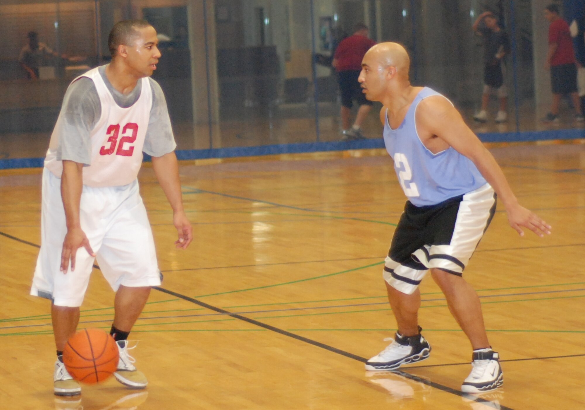 FAIRCHILD AIR FORCE BASE, Wash. -- 92nd Services Squadron’s Kevin Gilliam challenges the defensive skills of 92nd Civil Engineer Squadron’s James Gasaway during the second half of the under-30 intramural championship game.  (U.S. Air Force Photo / Staff Sgt. Michael Daniel)