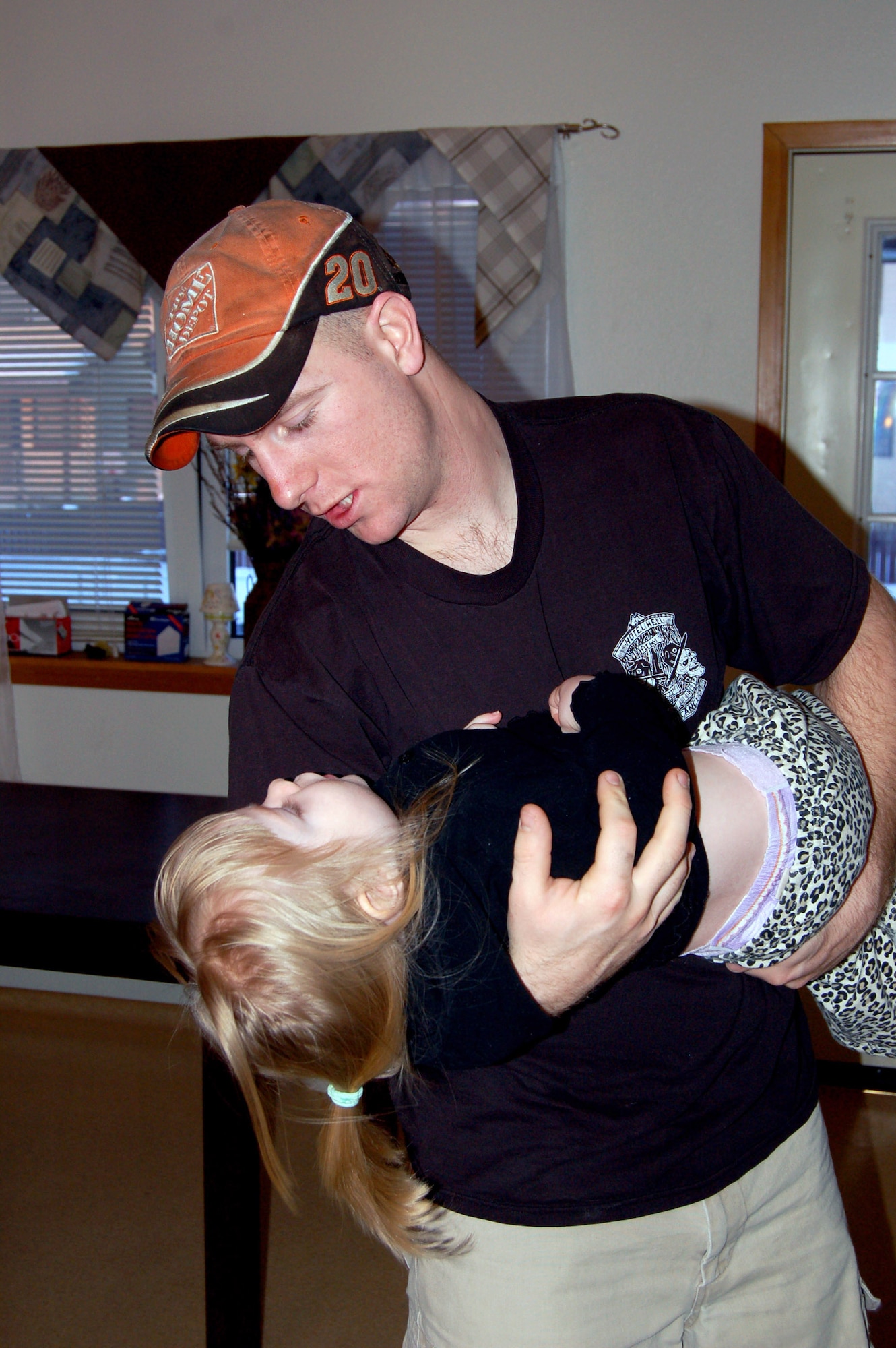 Staff Sgt. Philip Bridges tickles his 2-year-old daughter, Liberty, at their new home in base housing Feb. 27 at Eielson Air Force Base, Alaska. They were one of 300 families living in the Sprucewood Homes edition of the base's privatized housing. The Bridges and other Air Force families had to be moved out of the privatized housing into new housing from September to December. The reason for the move was due to a conclusion of a privatized housing contract that wasn't able to be renegotiated. (U.S. Air Force photo/Staff Sgt. Matthew Rosine) 
