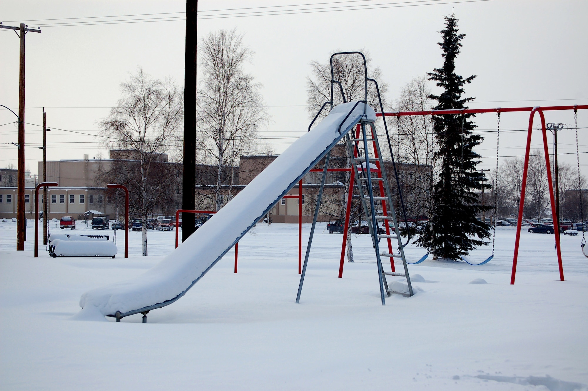 An abandoned playground sits covered in snow in the Sprucewood Homes section of base housing Feb. 27 at Eielson Air Force Base, Alaska. Three hundred Air Force families had to be moved out of the privatized housing into new housing from September to December. The reason for the move was due to a conclusion of a privatized housing contract that wasn't able to be renegotiated. (U.S. Air Force photo/Staff Sgt. Matthew Rosine)