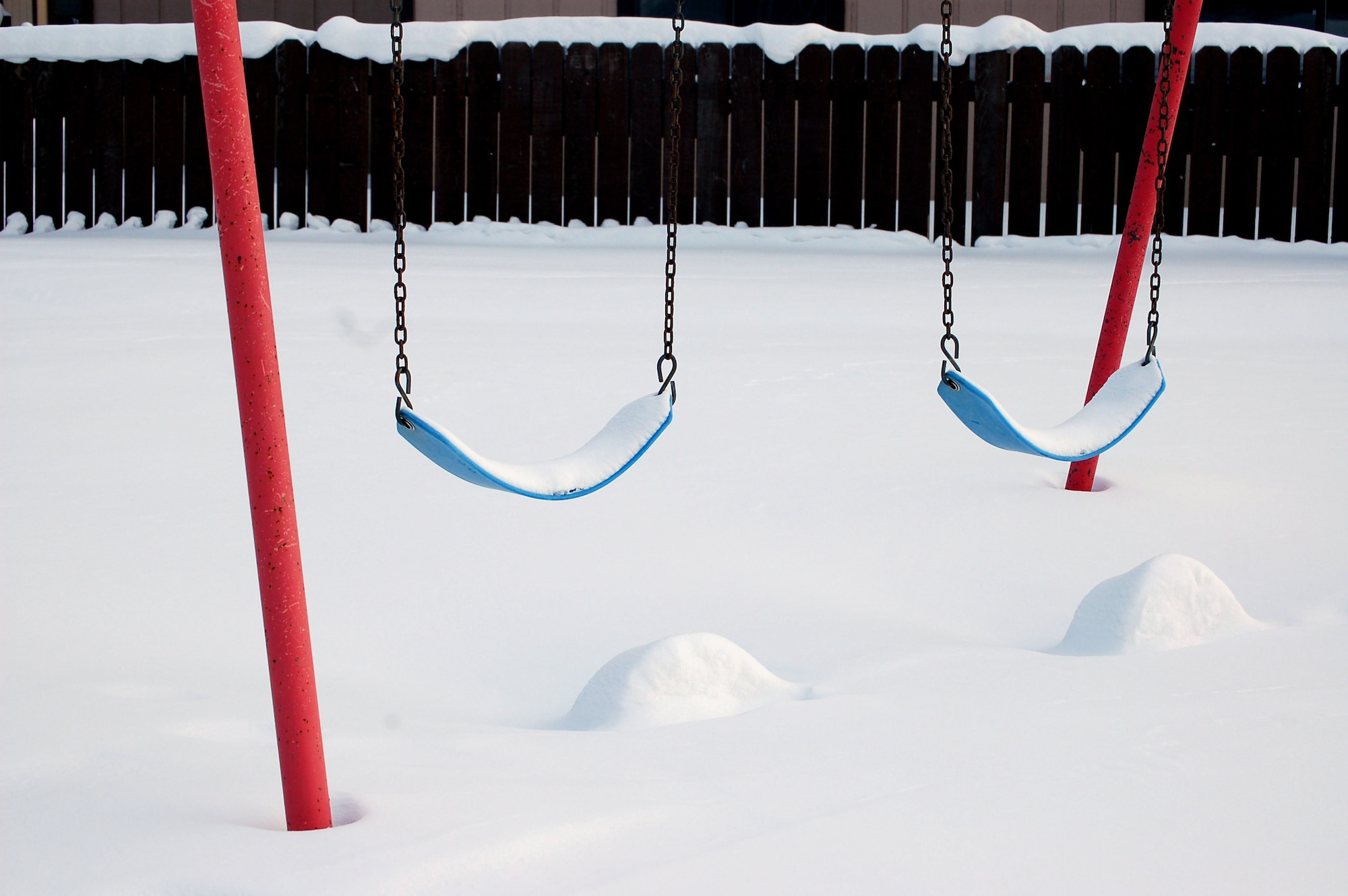 Abandoned swings sit covered in snow in the Sprucewood Homes section of base housing Feb. 27 at Eielson Air Force Base, Alaska. Three hundred Air Force families had to be moved out of the privatized housing into new housing from September to December. The reason for the move was due to a conclusion of a privatized housing contract that wasn't able to be renegotiated. (U.S. Air Force photo/Staff Sgt. Matthew Rosine) 
