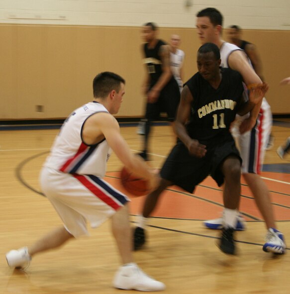 Players battle it out as the Commandos took on the Royal Air Force team in an exhibition game Feb. 22. (U.S. Air Force photo by Jamie Haig)