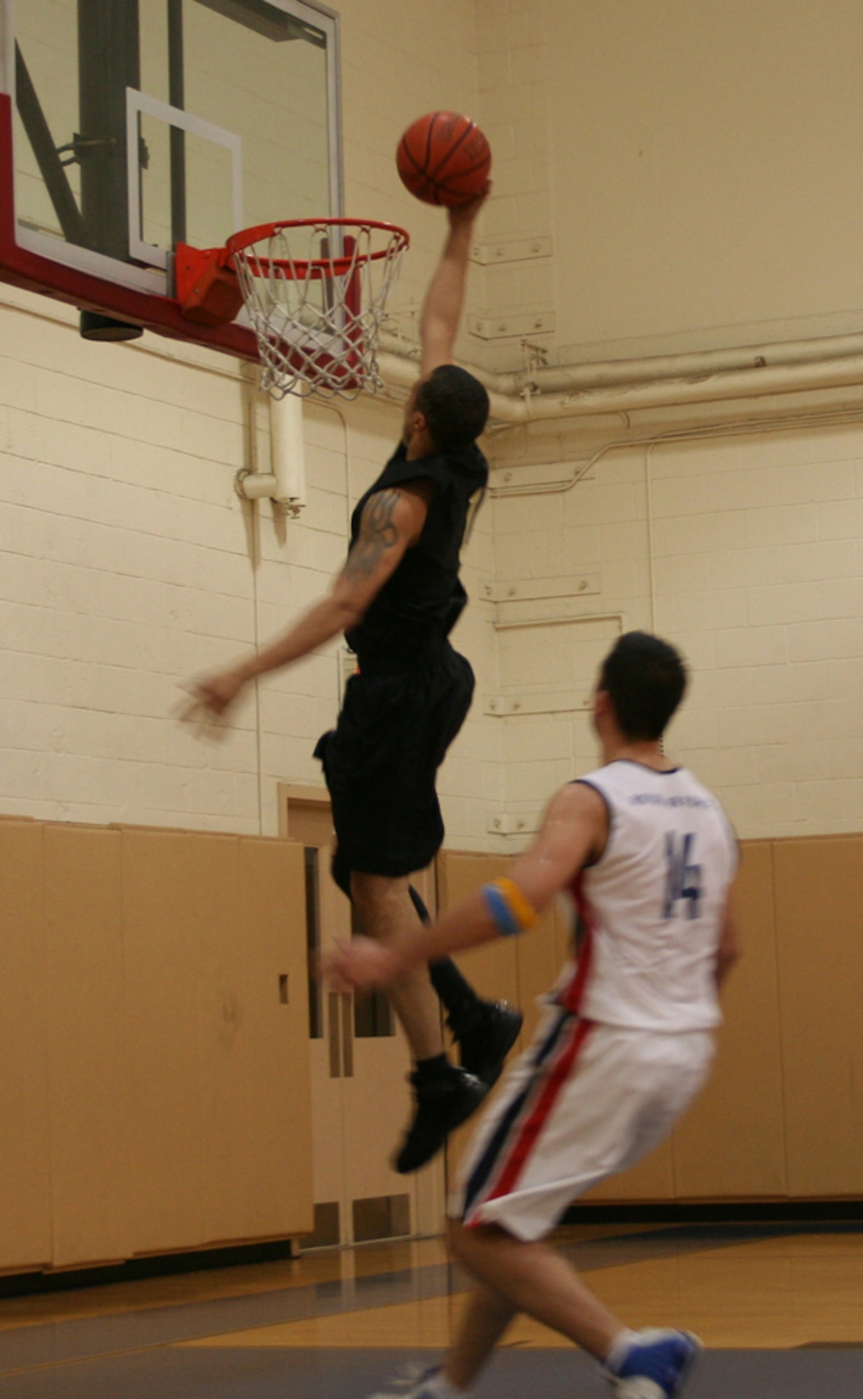 A Commando goes for a dunk during their game against the Royal Air Force Feb. 22. (U.S. Air Force photo by Jamie Haig)