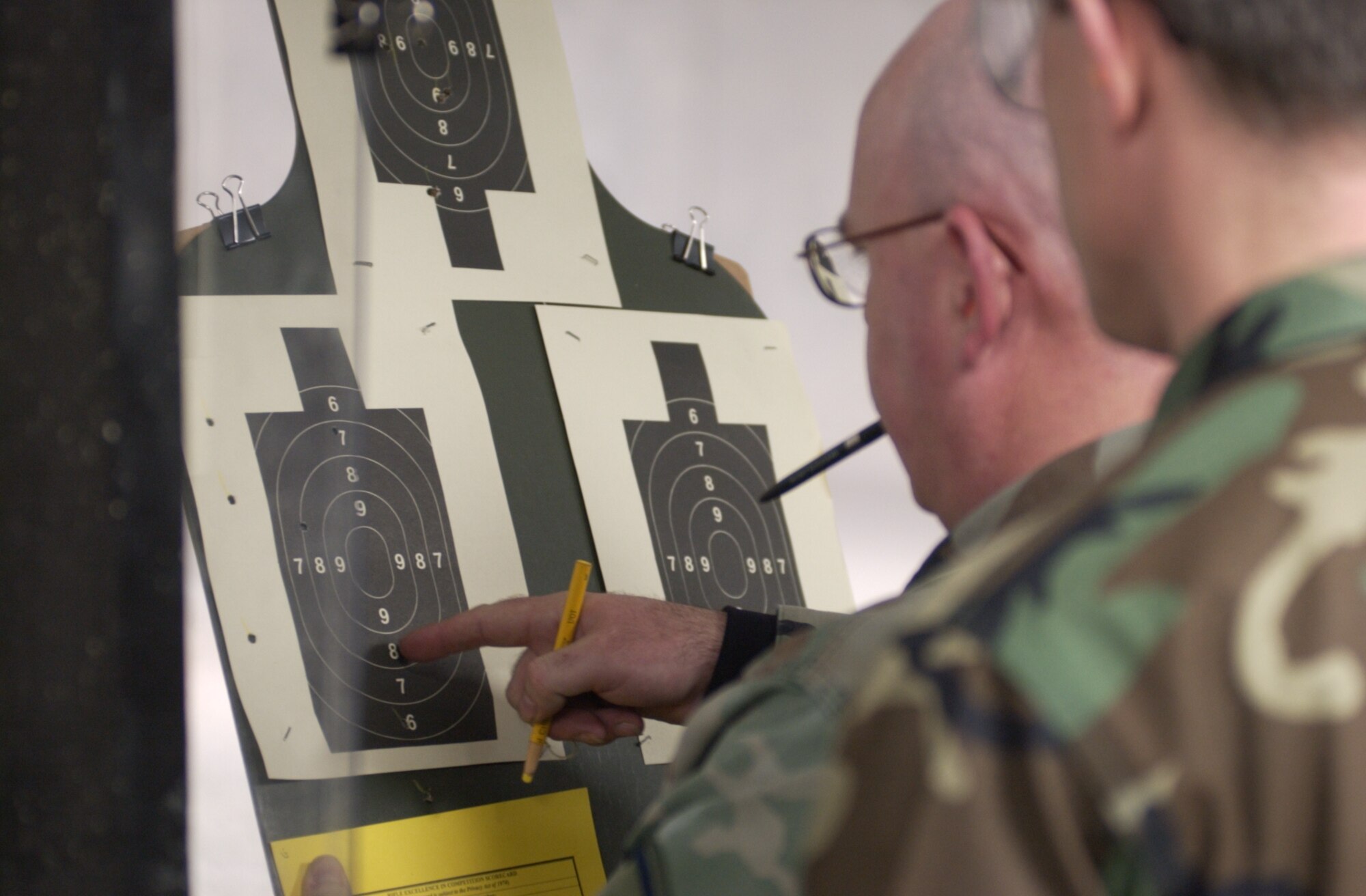 Master Sgt. John Ryan, a firing-line instructor, counts the score of Lt. Col. Doug Spaeth. Air Force photo by Spencer P. Lane