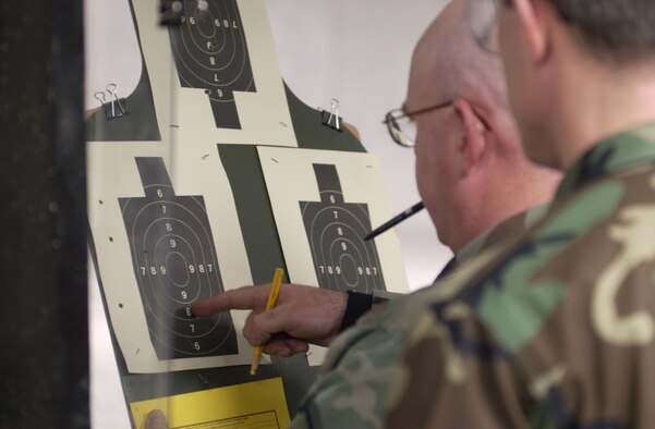 Master Sgt. John Ryan, a firing-line instructor, counts the score of Lt. Col. Doug Spaeth. Air Force photo by Spencer P. Lane