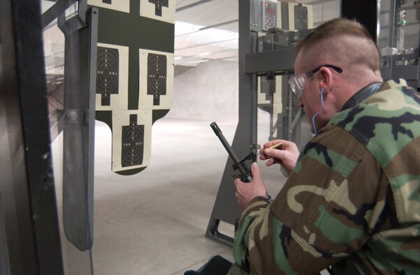 Capt. Brandon Ledbetter with the 663rd Aeronautical Systems Squadron makes an adjustment to his rilfe's sight before the competition begins. Air Force photo by Spencer P. Lane