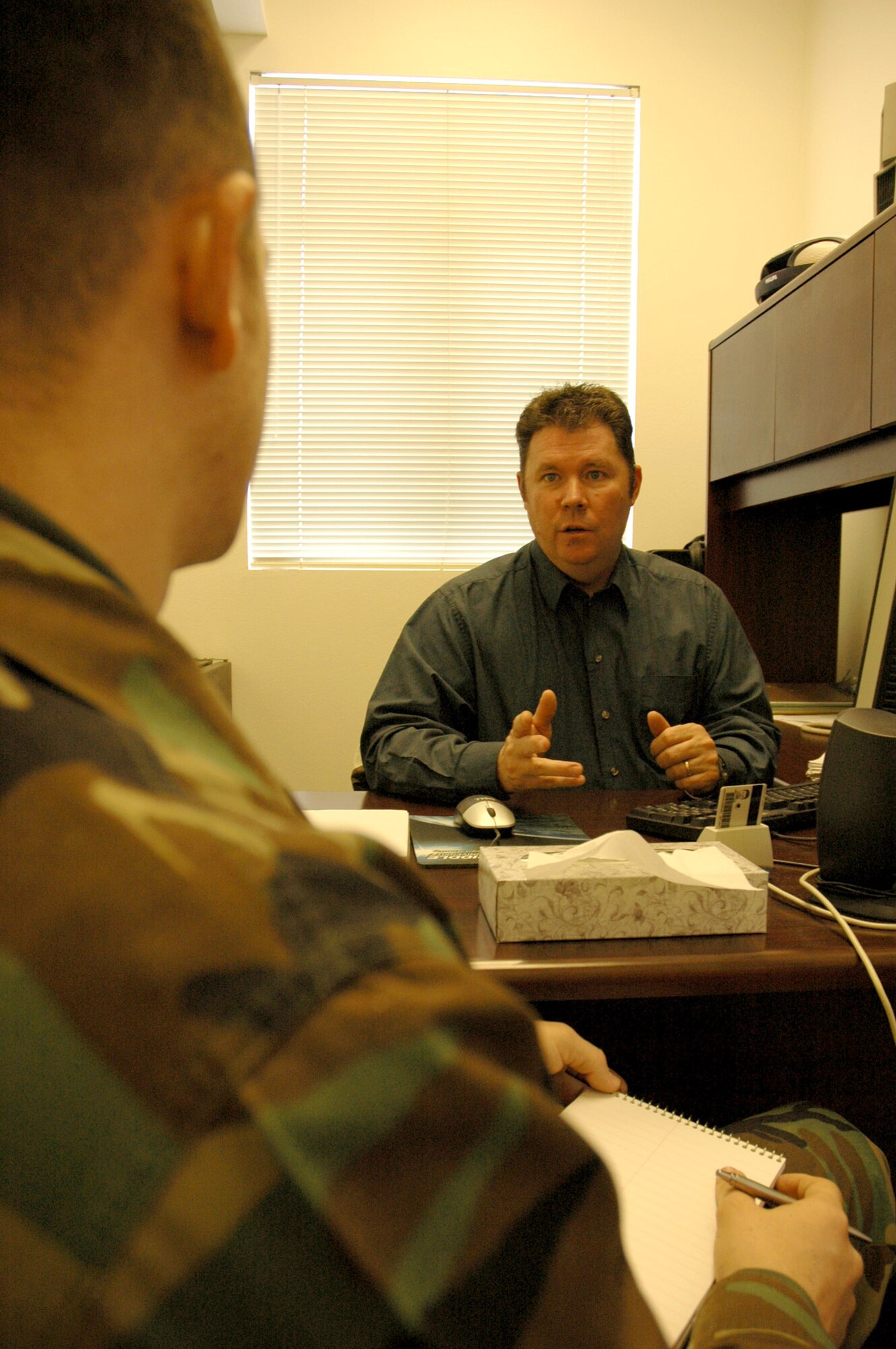 MOUNTAIN HOME AIR FORCE BASE, Idaho -- Bill McCarthy and Staff Sgt. Louis Lanton discuss inputs for an upcoming training exercise for the 726th Air Control Squadron. Air Force photo by Master Sgt. Brian S. Orban