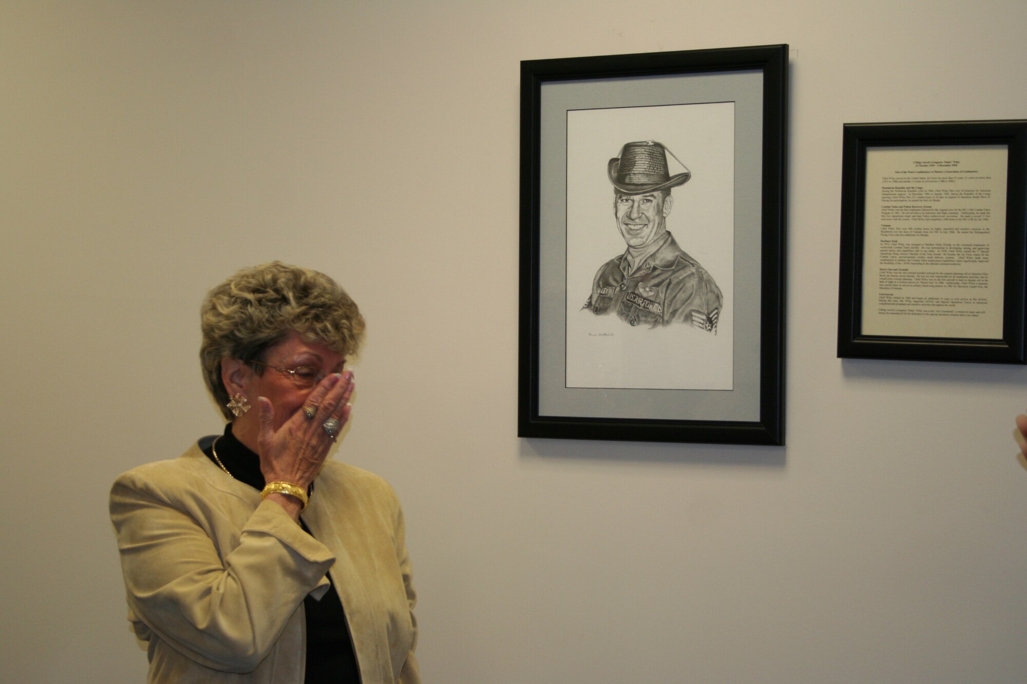 Linda Wiley sheds a tear during the dedication ceremony of the AFSOF conference room to Chief Master Sgt. Atwell Livingston "Duke" Wiley Tuesday. (U.S. Air Force photo by Jamie Haig)