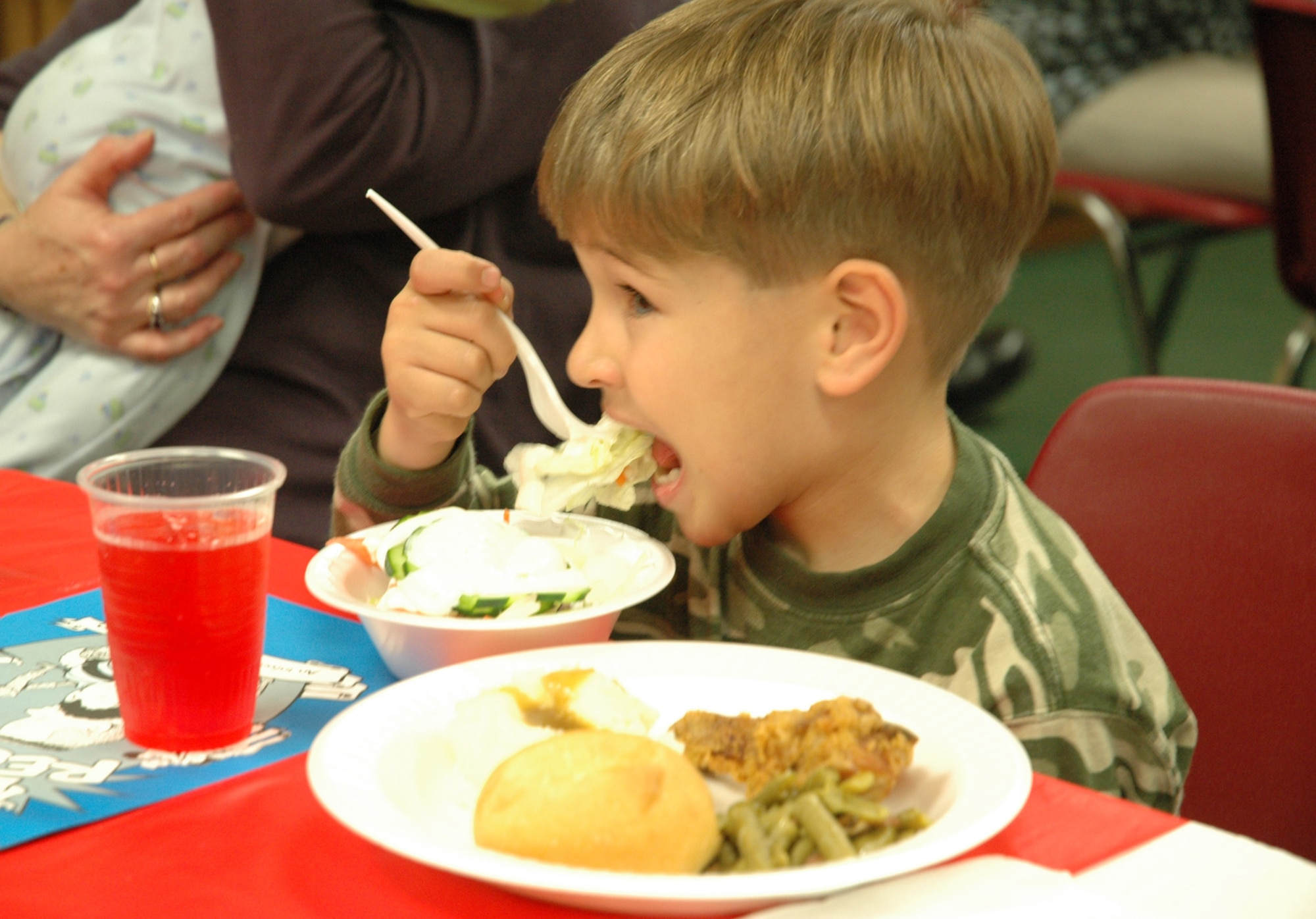 A child feasts on a home-made dinner during Salute to Families. The event was held for the families of deployed Airmen so they would know the services offered by the base while their loved ones are away. (U.S. Air Force photo by 1st Lt. Amy Cooper)