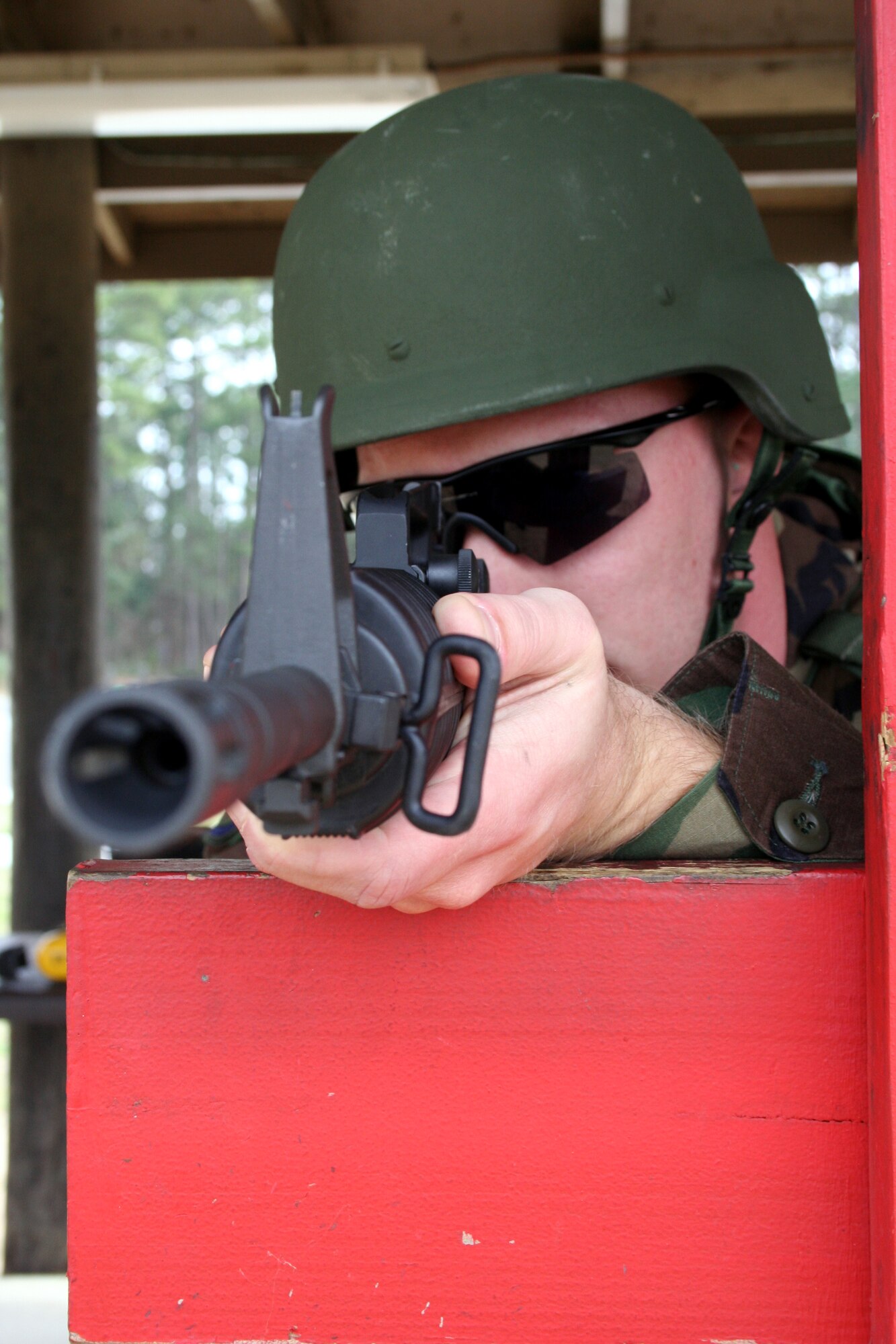 Staff Sgt. Kenneth Kline, a combat arms instructor with the 1st Special Operations Security Forces Squadron, takes aim downrange with an M4 at the Combat Arms Training and Maintenance firing range Wednesday. In an effort to make the shooting experience more realistic, Hurlburt Field now requires all shooters to wear vests and helmets. (U.S. Air Force photo by Staff Sgt. Angela Shepherd)