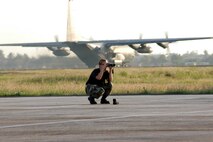 Staff Sgt. Sara Klobucar, a weather technician from the 353rd Operations Support Squadron at Kadena Air Base, Japan, uses a laser range finder to complete an airfield survey at Mactan Air Base, Philippines.  During her weather observation, she determines quadrant markers and landmarks that can be used to determine the required visibility to ensure safe flight.  In the background is a Combat Talon II, assigned to the 353 SOG and flown by members of the 1st Special Operations Squadron, also from Kadena, preparing for takeoff.  Both squadrons, part of the 353rd Special Operations Group, were participating in Balance Piston, a joint combined exchange training event at Mactan. (USAF photo by Master Sgt. Marilyn Holliday)                         