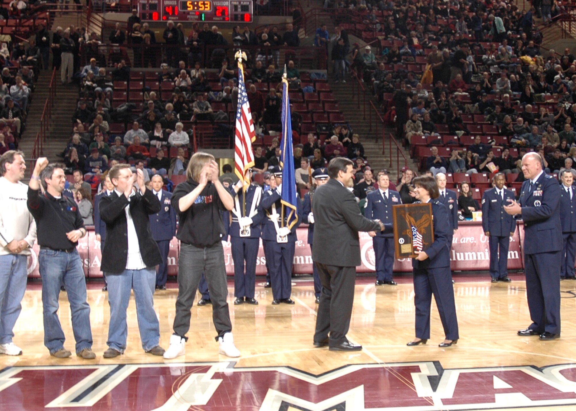 Brig. Gen. Suzanne Vautrinot, Air Force Recruiting Service commander, presents the American Spirit Award to 97.9 KIX-FM radio of Springfield, Mass., during halftime of the University of Massachusetts vs. Rhode Island men's basketball game in Amherst, Mass. Feb. 8. The 319th Recruiting Squadron in Portsmouth, N.H. nominated 97.9 KIX-FM for the command-level award for providing outstanding Air Force support. (U.S. Air Force photo by Tech. Sgt. Krista Herzog)