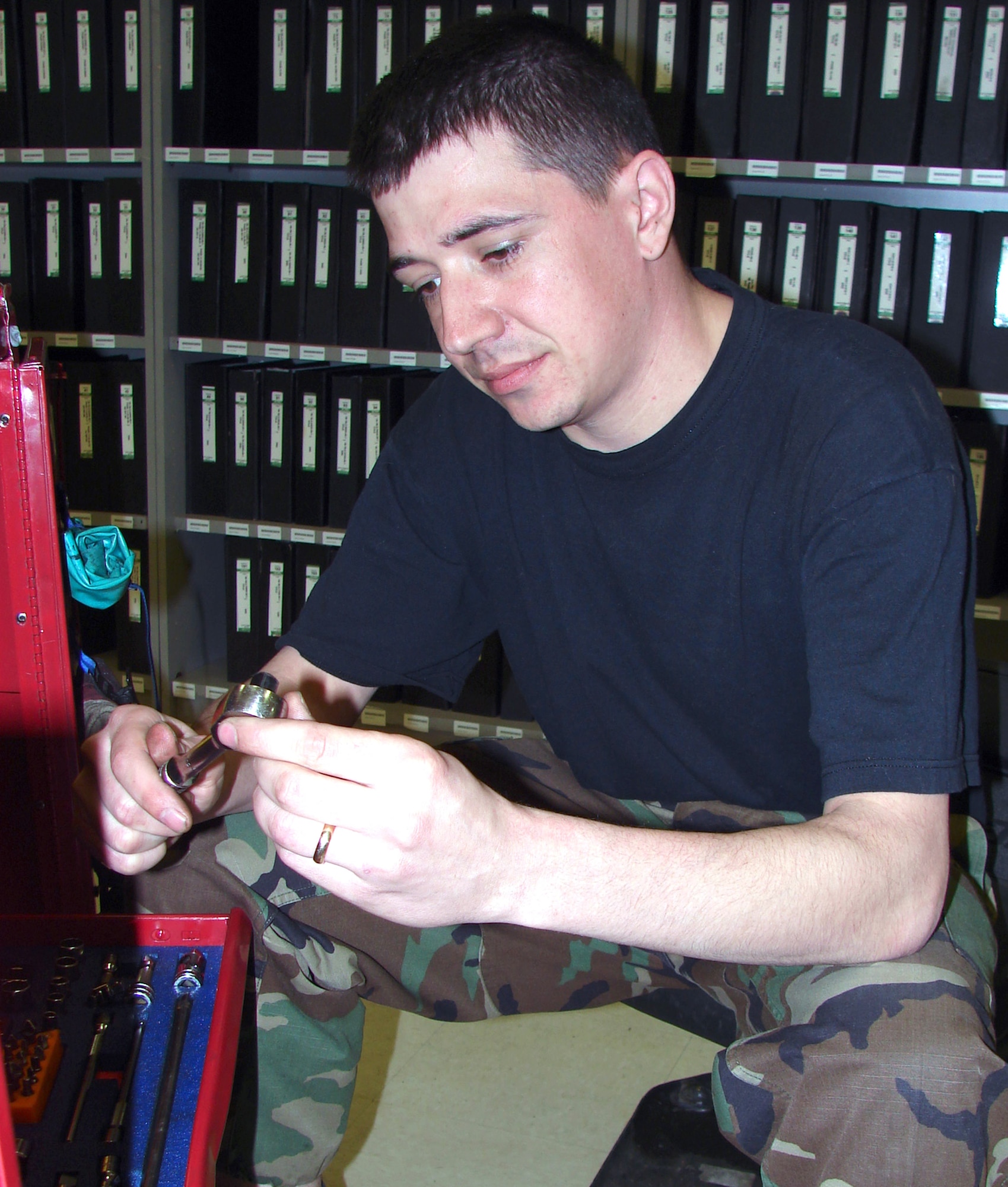 Staff Sgt. Johnathan Kovar organizes his toolbox Feb. 27 in the newly consolidated aircraft maintenance support flight at Dyess Air Force Base, Texas. Combining two maintenance units on the base has cut task time in half for maintainers and support specialists here. Sergeant Kovar is a support flight specialist with the 7th Aircraft Maintenance Squadron. (U.S. Air Force photo)                               