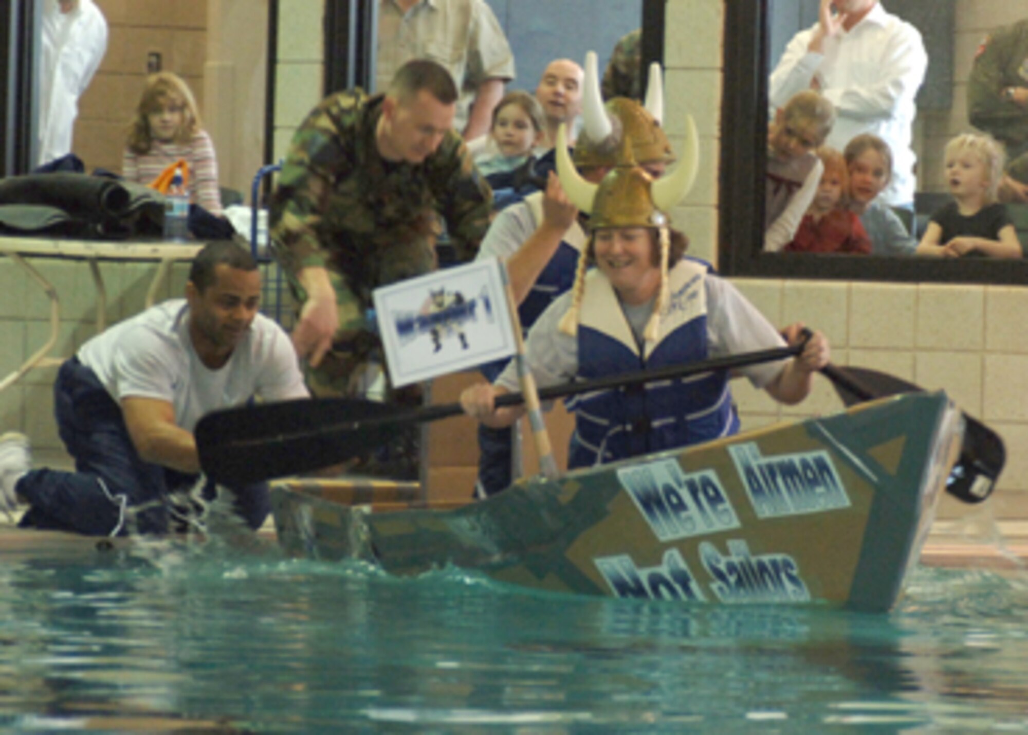 Col. Diane Hull, 319th Air Refueling Wing commander, and Chief Master Sgt. Jon Saiers, 319 ARW command Chief, start across the pool sporting Viking helmets during the Frosty Sailor race at Winter Bash Feb. 23. (U.S. Air Force photo/Staff Sgt. Suellyn Nuckolls)