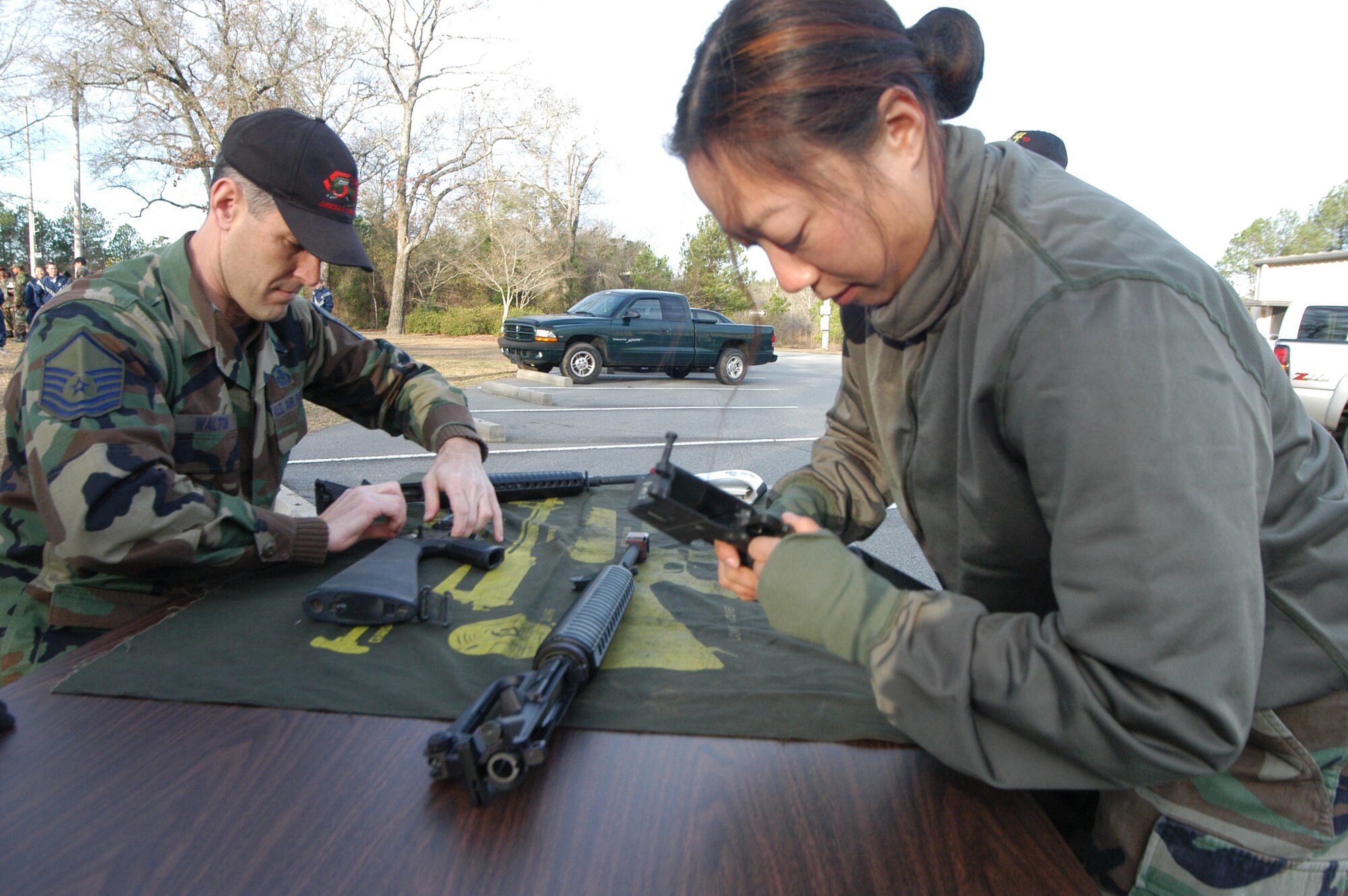 Senior Airman Wing Mihelcich, 5th Combat Support Squad-ron, field strips an M-16A2 during the gator challenge relay race. Teams had to field strip, reassemble and function check the weapon. U.S. Air Force photo by Sue Sapp.