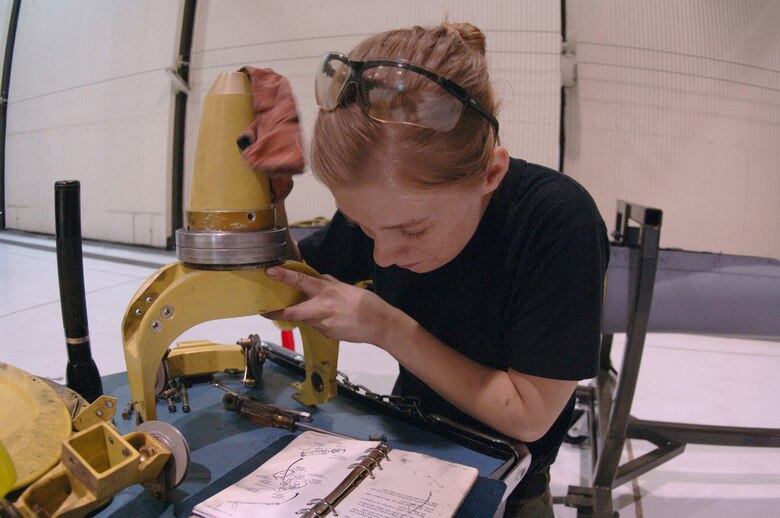 GRAND FORKS AIR FORCE BASE, N.D. –Airman Basic Rebecca Perkins, 319th Maintenance Squadron hydraulics apprentice, consults technical data as she inspects part of the boom assembly on a KC-135 Stratotanker during a periodic inspection here Feb. 27.  More than eight career fields and 50 Airmen work together to ensure the 50-year-old backbone of the Air Force’s global reach ability is ready for service throughout the world. (U.S. Air Force photo/Airman 1st Class Chad Kellum)  