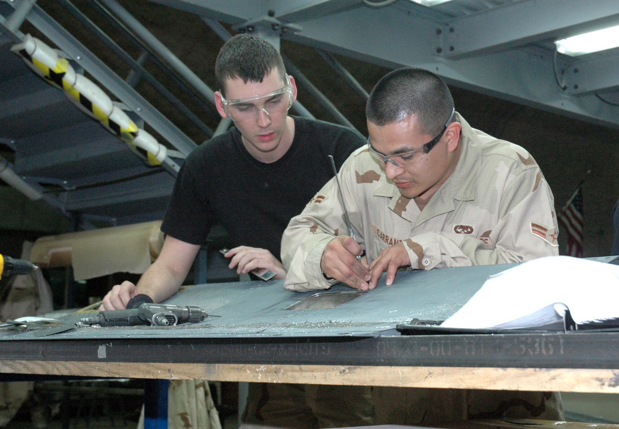 Senior Airman Ryan VanArtsdalen (left) and Airman 1st Class Jaime Carranza repair a No. 2 spoiler from a KC-135 Stratotanker Feb. 20 in Southwest Asia. The Airmen are aircraft structural maintenance journeymen deployed with the 379th Expeditionary Maintenance Squadron. (U.S. Air Force photo/Senior Airman Erik Hofmeyer) 