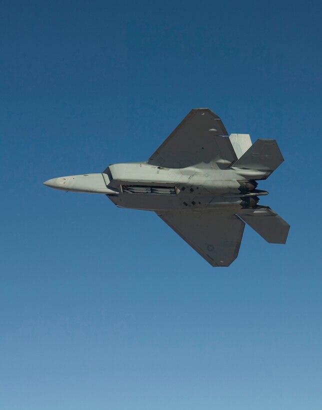 An F-22A Raptor flies Feb. 2, 2007, with four Small Diameter Bombs on board. Pilots and engineers from the F-22 Combined Test Force were performing load tests to ensure the GBU-39/B Small Diameter Bomb system does not exceed structural load boundaries for the Raptor. (Photo by Darin Russell)