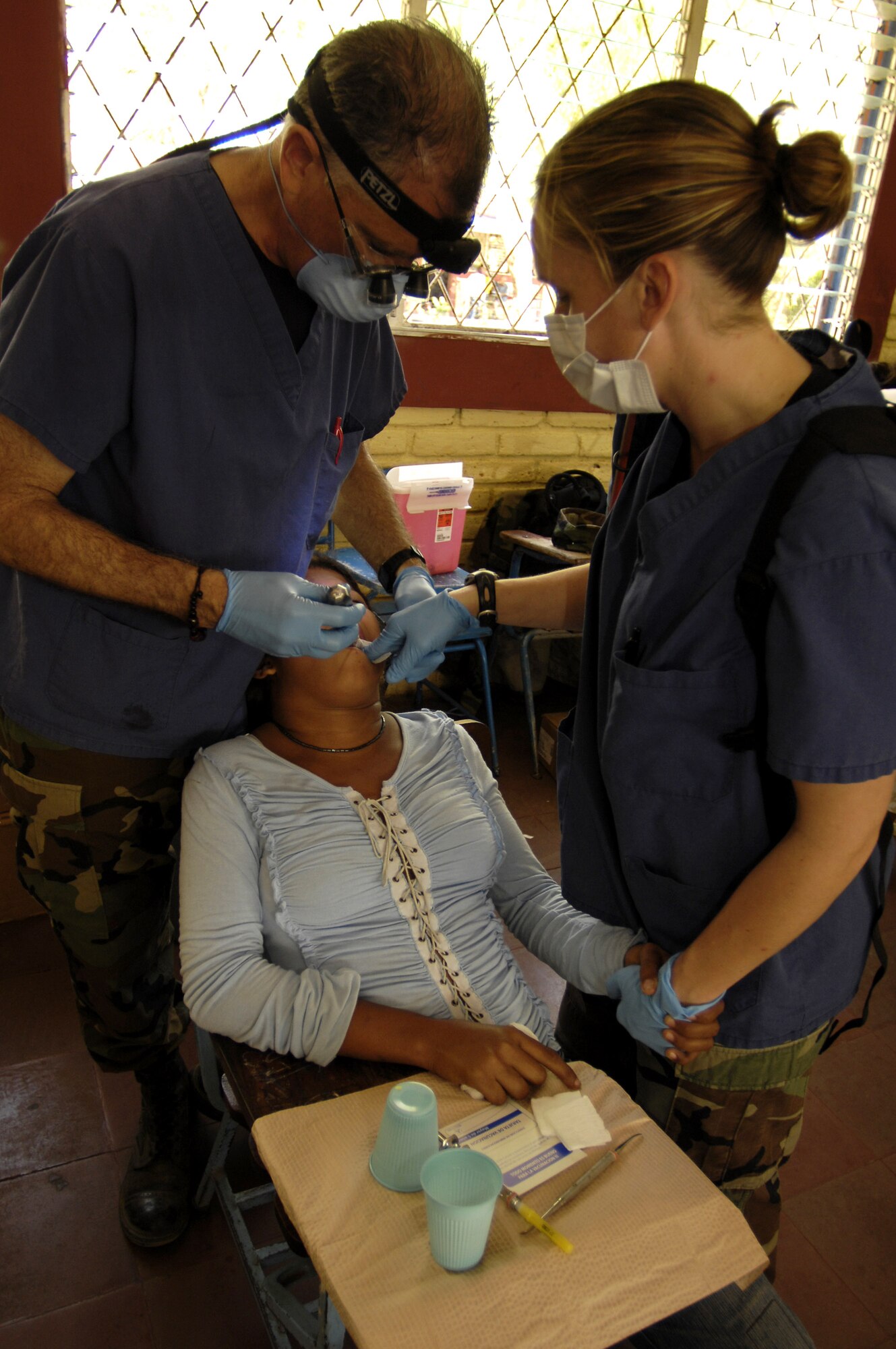 Lt. Col. Robert Reinhart and Staff Sgt. Elizabeth Aravjo examine a patient's teeth while participating in Medical Readiness Training Exercises in Santa Teresa Feb. 26 during New Horizons - Nicaragua 2007. The $7.25 million joint U.S. and Nicaraguan military humanitarian and training exercise, provides a new school and medical clinic, as well as free health and veterinary care, giving aid and strengthening bonds between the two nations. Colonel Reinhart and Sergeant Aravjo are from the 9th Medical Group at Beale Air Force Base, Calif. (U.S. Air Force photo/Tech. Sgt. Kevin P. Milliken)
