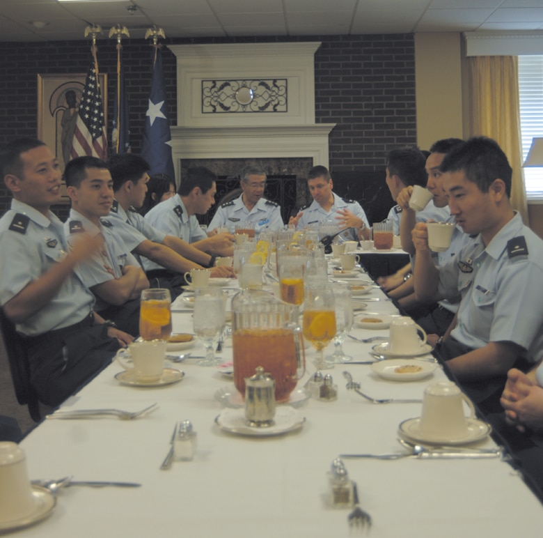 Lieutenant Gen. Osamu Arano, Commander of the Air Training Command for the Japanese Air Self-Defense Force, Japan, and Colonel Eric Theisen, 14th Operations Group Commander, enjoy lunch with the Columbus AFB Japanese specialized undergraduate pilot training students at the base club Wednesday. (Photo by 2nd Lt. Justin Jarrell)