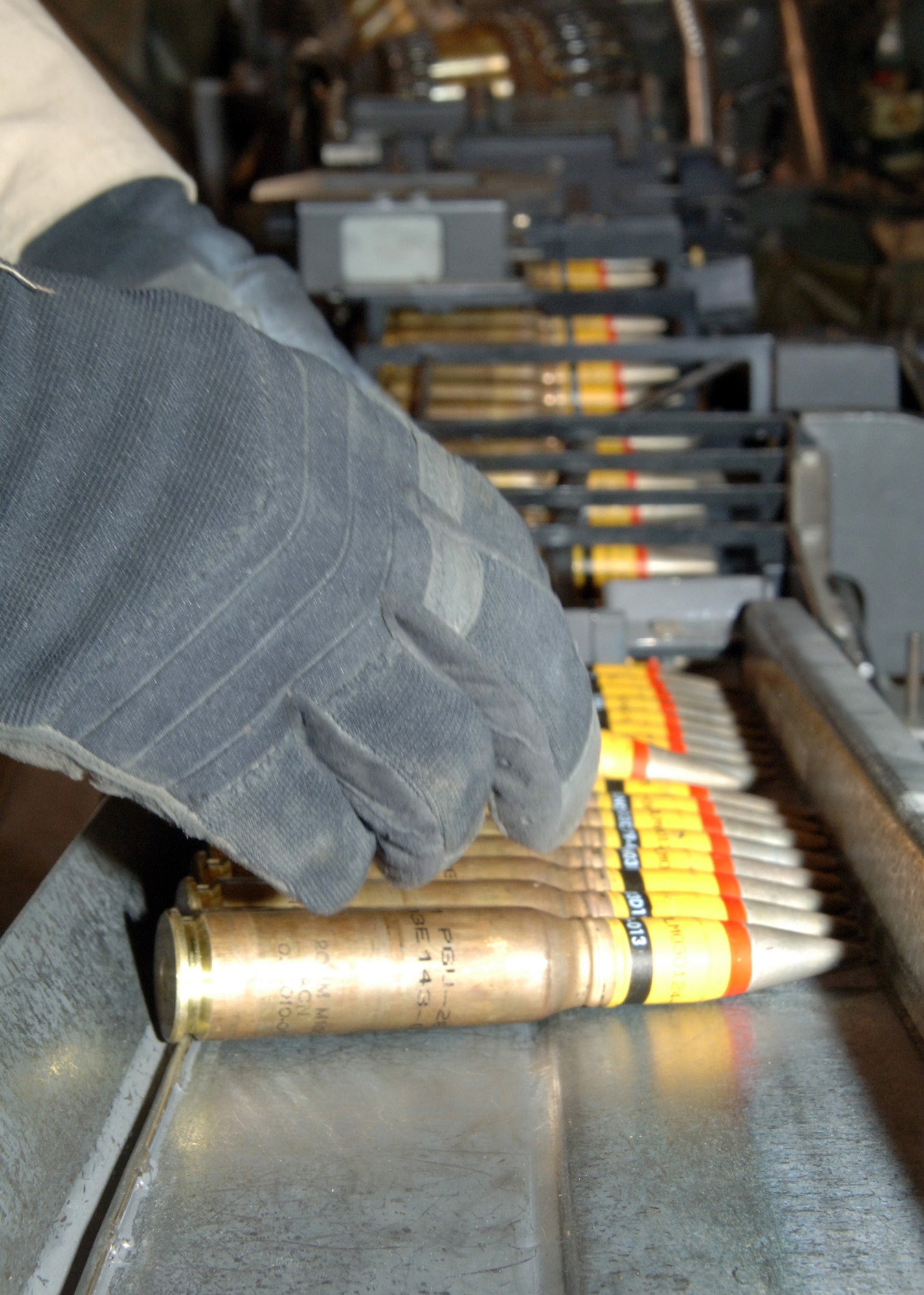 BALAD AIR BASE, Iraq -- High Explosive Incendiary PGU-28A/B 20mm cannon rounds are fed through a 'replenisher' (foreground) into a Universal Ammunition Loading System (UALS). UALS are then used to transfer the cannon rounds directly into F-16 weapon systems. The new PGU cannon rounds were first validated at a firing range Feb. 22, then used in battle against insurgents east of Baghdad Feb. 26.  (U.S. Air Force photo/Capt. Ken Hall)