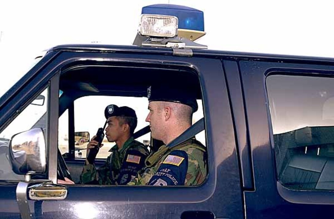 Alaska Army National Guard Sgt. Gerald Mullins (front), the driver, and Spc. Jerel Morrill patrol the flight line at Kulis Air National Guard Base in Anchorage. The two are normally infantry scouts, but volunteered to be part of the base security force for at least the next year. Photo by Master Sgt. Bob Haskell, USA.