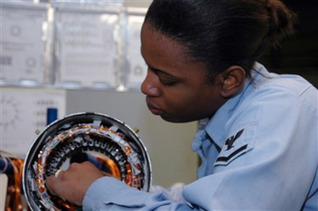 U.S. Navy Petty Officer 3rd Class Danielle Brown, assigned to USS Carl Vinson, repairs electrical wiring on a piece of machinery in the light industrial facility at Newport News, Va., Feb. 21, 2007. The Vinson is undergoing a scheduled refueling complex overhaul at Northrop Grumman Newport News shipyard. 