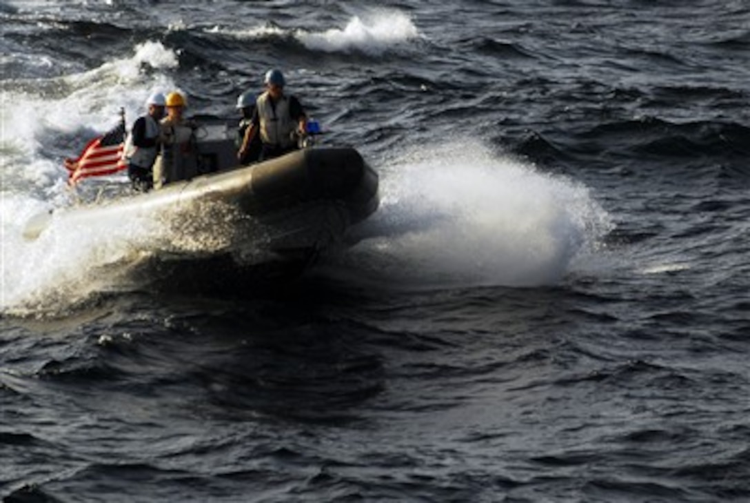 U.S. Navy sailors attached to the aircraft carrier USS John C. Stennis (CVN 74) ride aboard a rigid hull inflatable boat during small boat operations in the Arabian Sea on Feb. 27, 2007.  The USS John C. Stennis Carrier Strike Group is deployed in support of maritime security operations in the area.  