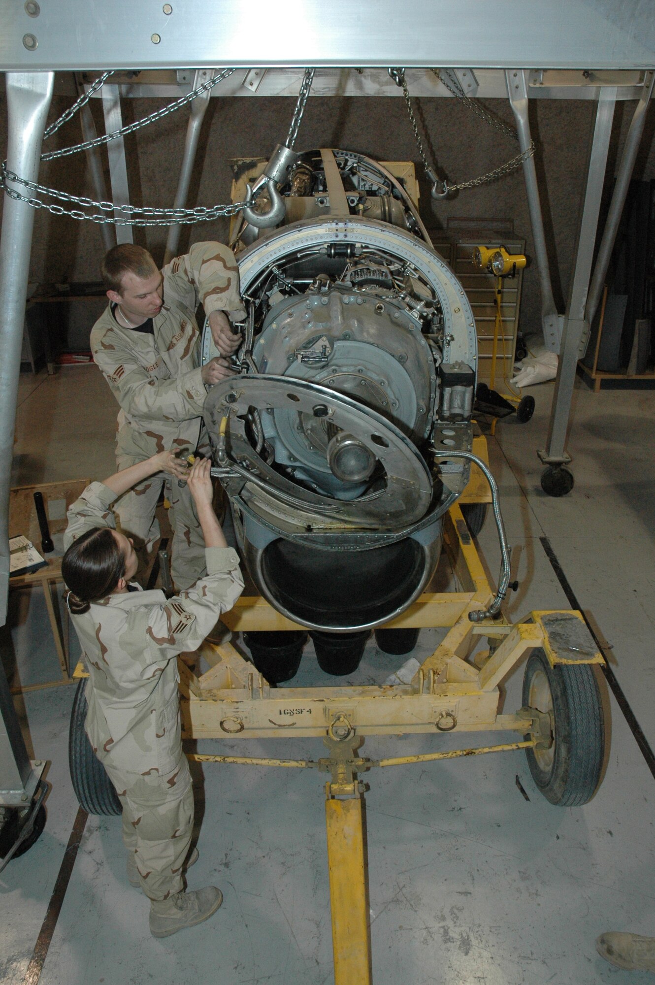 Airmen from the 379th Expeditionary Maintenance Squadron perform maintenance on a C-130 engine. Airmen rebuild, maintain, and operationally check C-130 engines and propellers in the Centralized Intermediate Repair Facility that serves the entire AOR (U.S. Air Force photo by Senior Airman Erik Hofmeyer)
