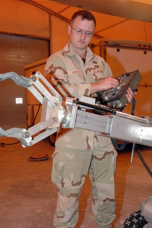 Senior Airman Matthew Abbott, 379th Expeditionary Civil Engineer Squadron Explosive Ordnance Disposal journeyman, performs a pre-operation inspection of an F6 EOD response robot. The function tests are necessary to ensure a full range of motion before shipping it to EOD technicians uprange. (U.S. Air Force photo by Senior Airman Erik Hofmeyer)