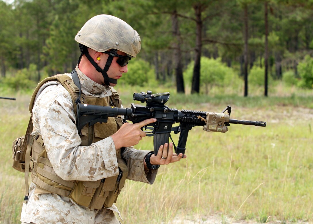 A Marine from Company C, 2nd Reconnaissance Battalion, 2nd Marine Division; loads his weapon during a live fire exercise aboard Marine Corps Base Camp Lejeune, N.C., May 19, 2011. The purpose of the exercise was to train the Marines within the company to maneuver under fire.