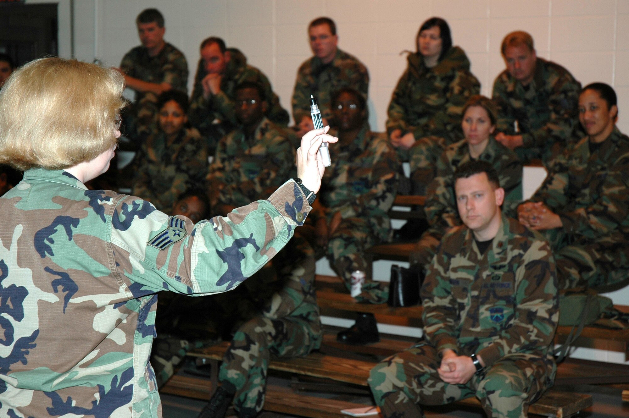 KEESLER AIR FORCE BASE, Miss. -- Senior Airman Jana Robinson, readiness specialist with the 81st Civil Engineer Squadron, explains how an atropine injector works during a Nuclear, Biological and Chemical training class held during March UTA. Members of the 403rd Wing who took part in the training also inspected their gas masks and practiced donning and doffing the mask. (U.S. Air Force photo/Tech. Sgt. Michael Duhe)  