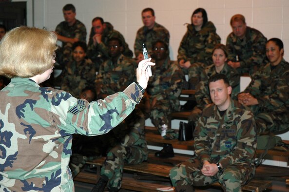 KEESLER AIR FORCE BASE, Miss. -- Senior Airman Jana Robinson, readiness specialist with the 81st Civil Engineer Squadron, explains how an atropine injector works during a Nuclear, Biological and Chemical training class held during March UTA. Members of the 403rd Wing who took part in the training also inspected their gas masks and practiced donning and doffing the mask. (U.S. Air Force photo/Tech. Sgt. Michael Duhe)  