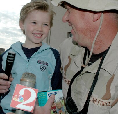 Staff Sgt. Ken Chapman, a Rescue Wing electrician with the 920th Maintenance Squadron, and his young son talk to the media prior to leaving for a deployment to Afghanistan.  In addition to aircraft maintainers, pararescuemen from the 308th Rescue Squadron as well as aircrew members from the 301st Rescue Squadron make up a large portion of the deployers.  Also included in the deployment are life support, safety and administrative support personnel.