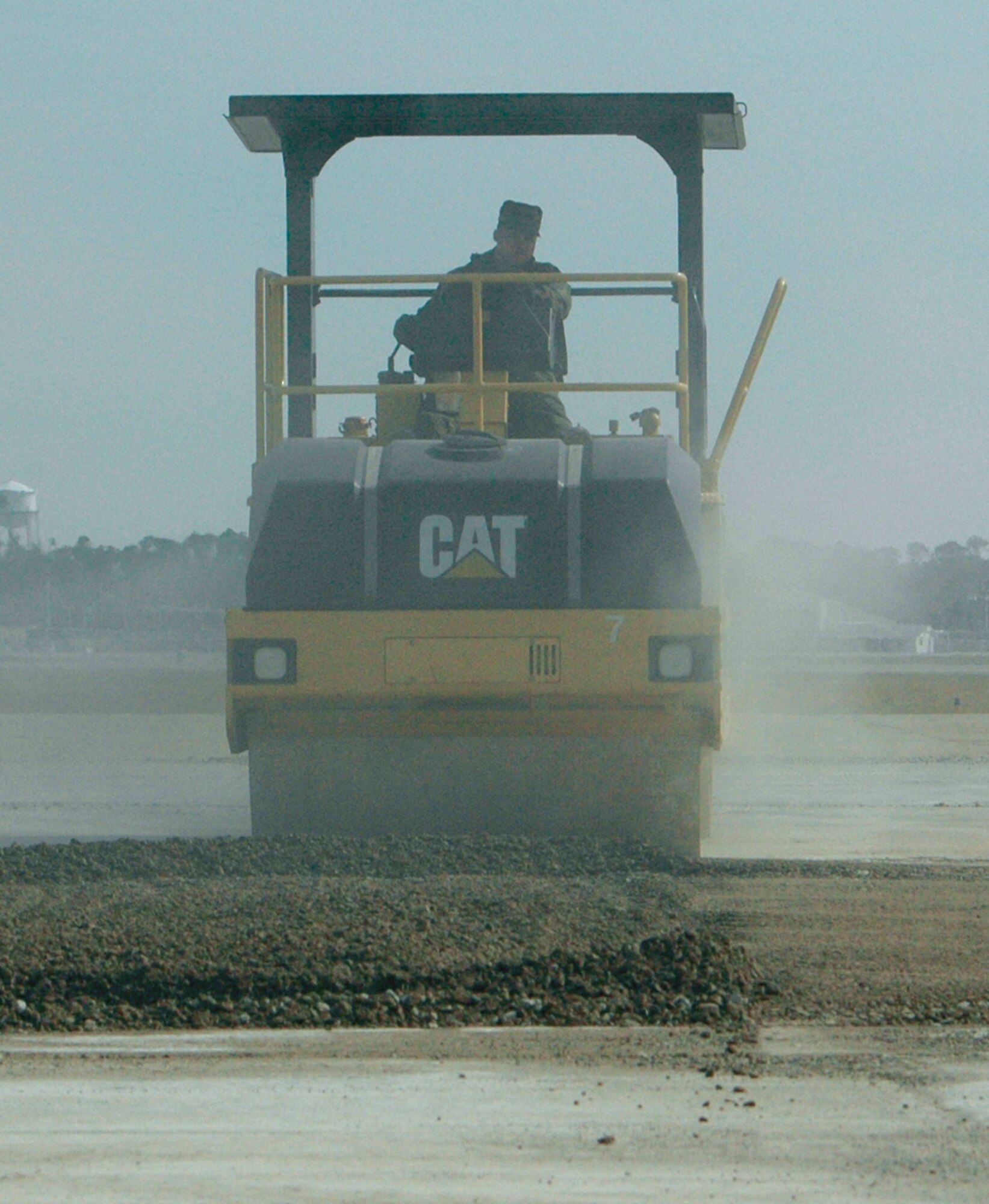Gulfport, Miss. -- Operating a steam roller, Tech. Sgt. David Boudreaux puts finishing touches on a damaged runway. Sergeant Boudreaux and others from the the 403rd Civil Engineer Squadron practiced their wartime skills in a remote area of of the Combat Readiness Training Center, Gulfport at February's Unit Training Assembly. The scenario involved the rapid repair of a section of runway rendered unusable by a bomb attack. Using a combination of heavy equipment, Airmen from the squadron quickly filled the "bomb" crater with gravel and smoothed it over. In addition, CES firefighters also trained in the area, responding to emergency situations in various Mission Oriented Proctective Posture levels. (U.S. Air Force Photo/Tech. Sgt. Michael Duhe)