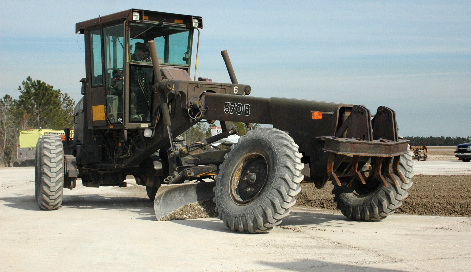 Gulfport, Miss. -- Staff Sgt. Michael Casey uses a road grader to level excess gravel while repairing a section of "bomb-damaged" runway.  Members of the the 403rd Civil Engineer Squadron practiced their wartime skills in a remote area of of the Combat Readiness Training Center, Gulfport at February's Unit Training Assembly. The scenario involved the rapid repair of a section of runway rendered unusable by a bomb attack. Using a combination of heavy equipment, Airmen from the squadron quickly filled the "bomb" crater with gravel and smoothed it over. In addition, CES firefighters also trained in the area, responding to emergency situations in various Mission Oriented Proctective Posture levels. (U.S. Air Force Photo/Tech. Sgt. Michael Duhe)