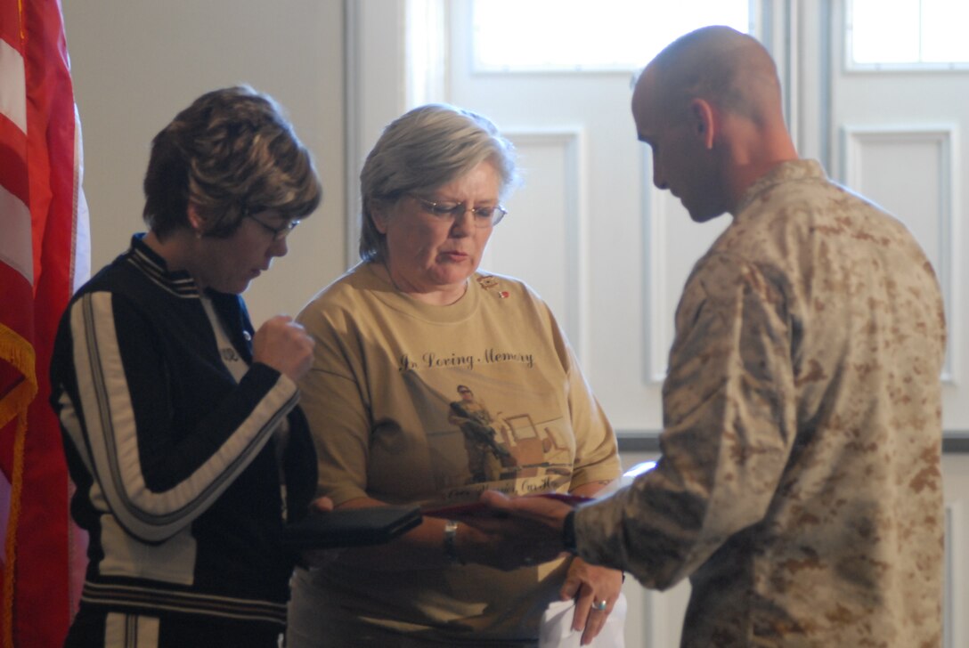 Christie Otten and Pat Ayscue, the mother and grandmother of Pfc. Enrique C. Sanchez, receive the Bronze Star Medal from Lt. Col. Matthew St. Clair, battalion commander for 3rd Battalion, 8th Marine Regiment, during an award ceremony aboard Camp Lejeune. Sanchez was awarded the medal for heroic achievement while serving as a turret gunner with 3rd Battalion, 8th Marine Regiment, 1 Brigade Combat Team, I Marine Expeditionary Force (Forward).