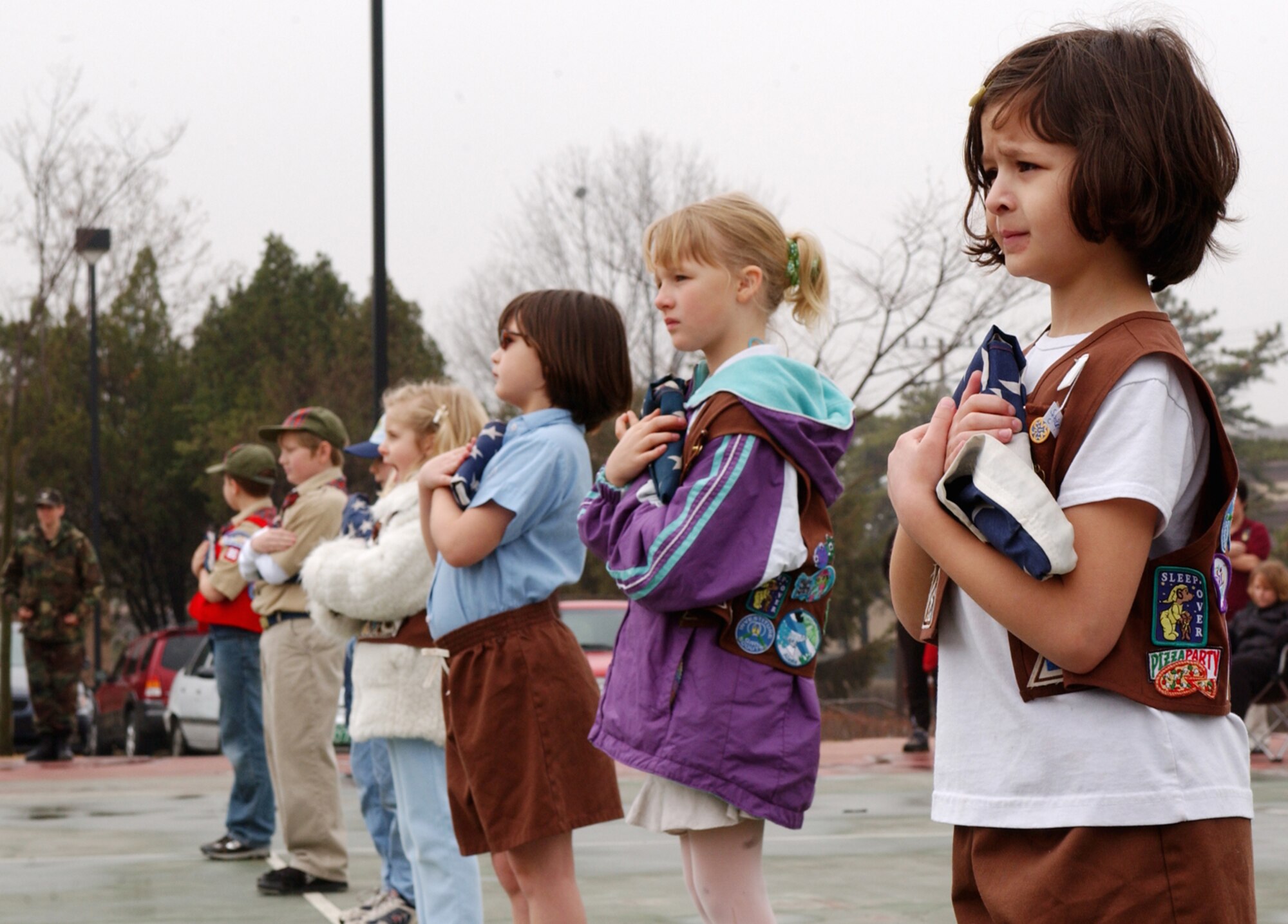 OSAN AIR BASE, Republic of Korea --  Members of the Osan Girl Scouts and Boy Scouts take part in a flag retirement ceremony here Saturday. The scouts participated in the event with the Osan Base Honor Guard in retiring eight U.S. flags. (U.S. Air Force photo by Airman Jason Epley)