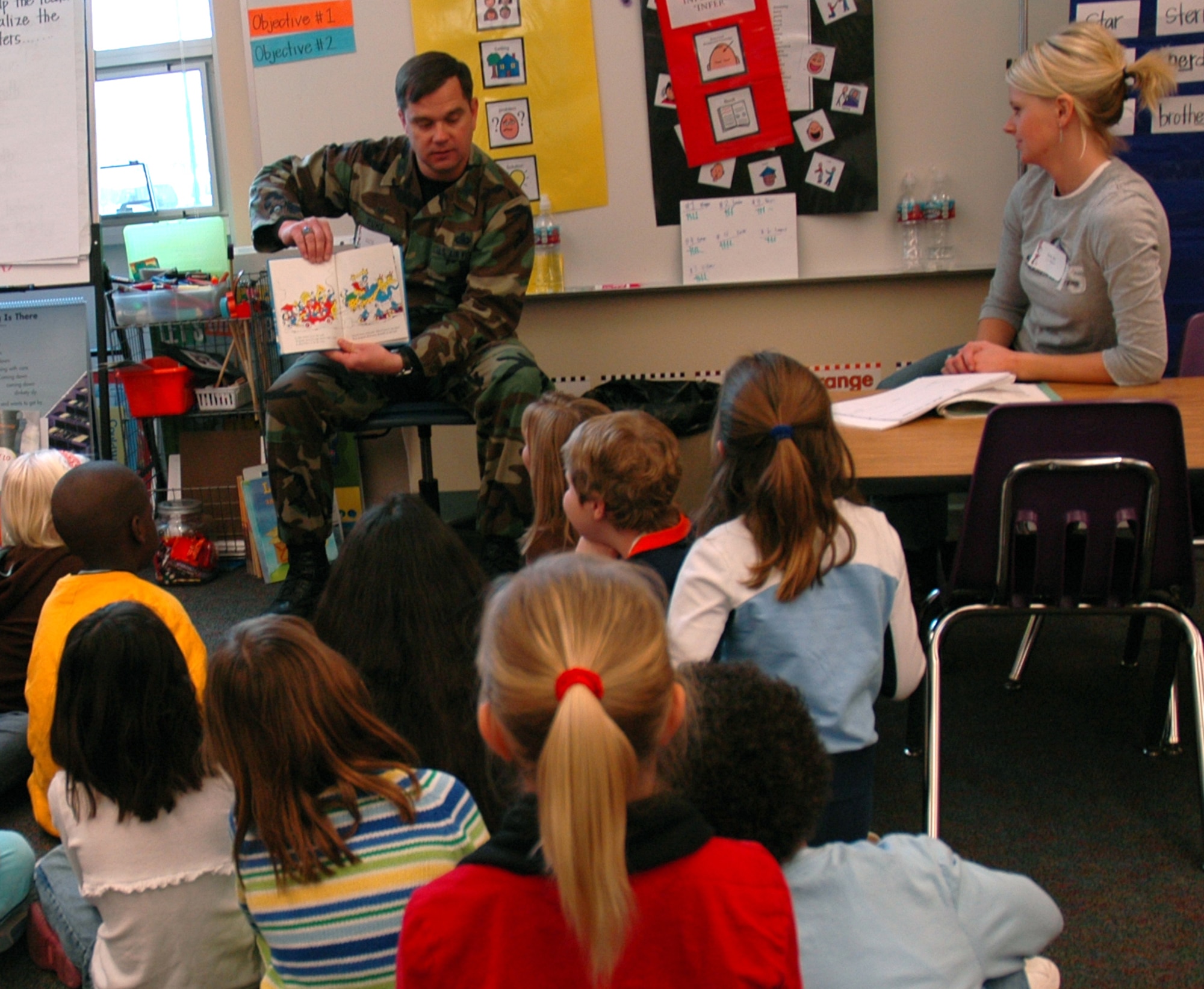 Col. Steven Muhs, 460 Mission Support Group commander, reads "And to Think that I saw it on Mulberry Street" to a group of first and second graders at Murphy Creek K - 8. March 2 was the National Education Association's Read Across America day where volunteers come out to local schools to read to children. The date coincides with the birthday of Dr. Seuss. (U.S. Air Force photo by Staff Sgt. Sanjay Allen)