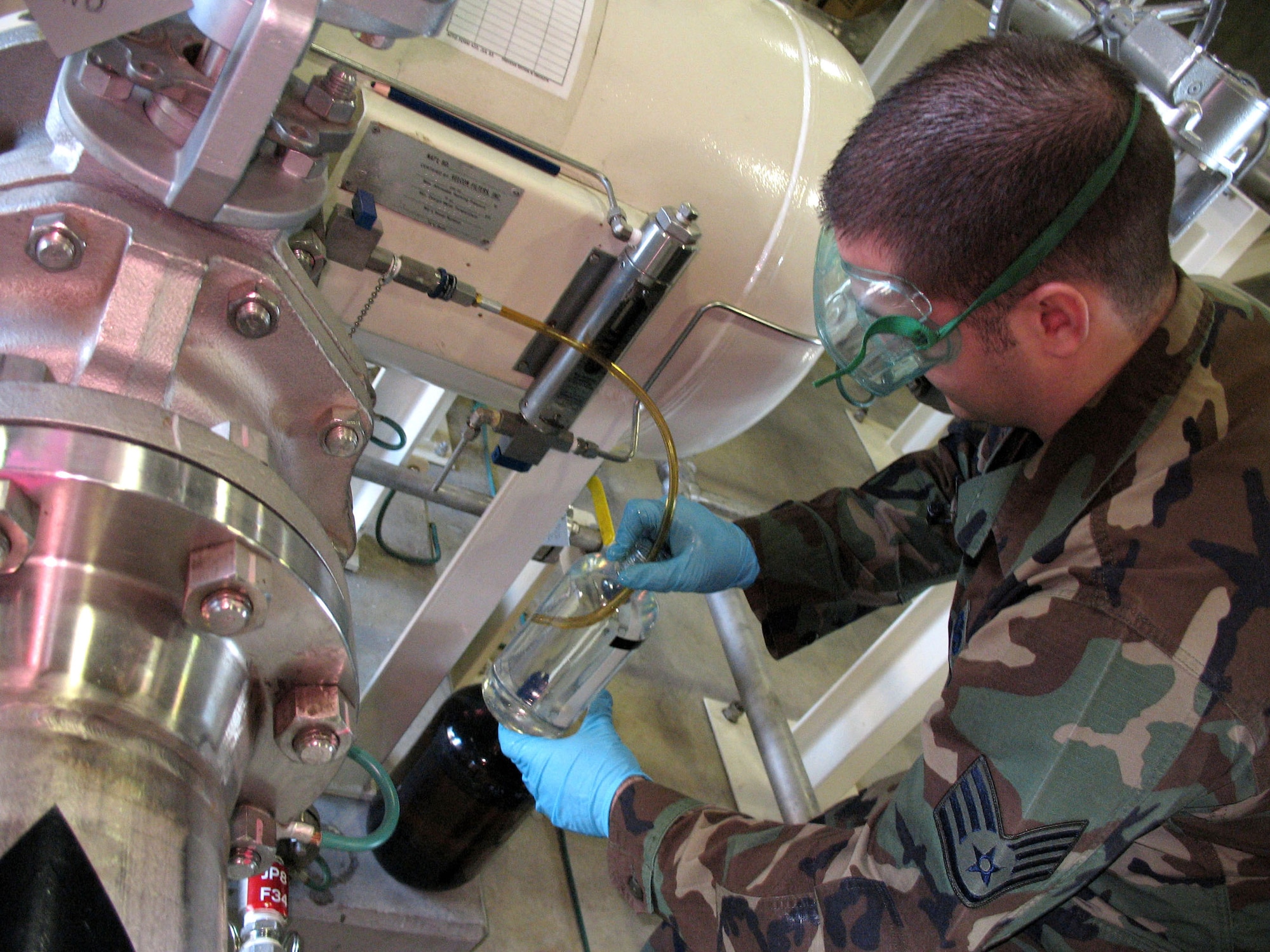 Staff Sgt. Mike Perrino takes a fuel sample from the latest shipment to Misawa Air Base, Japan. Tests need to be run on all the Diesel, JP-8 and MOGAS to come onto base. Sergeant Perrino is the NCO in charge of the 35th Fighter Wing's Fuel Laboratory. (U.S. Air Force photo/Senior Airman Gena Armstrong)
