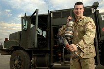 BALAD AIR BASE, Iraq -- Staff Sgt. Chad Warren, 332nd Expeditionary Logistics Readiness Squadron noncommissioned officer in charge of the fuels control center, sets up the R-11 aircraft refueling tank truck for operations Feb. 13 at Balad Air Base, Iraq. Sergeant Warren is deployed from Minot Air Force Base, N.D. Airmen with the petroleum, oil and lubricant flight recently received and issued a record-breaking 3.6 million gallons of fuel by tank truck and R-11 refueling units to every type of aircraft that touched down here in January. (U.S. Air Force photo by Airman 1st Class Nathan Doza)