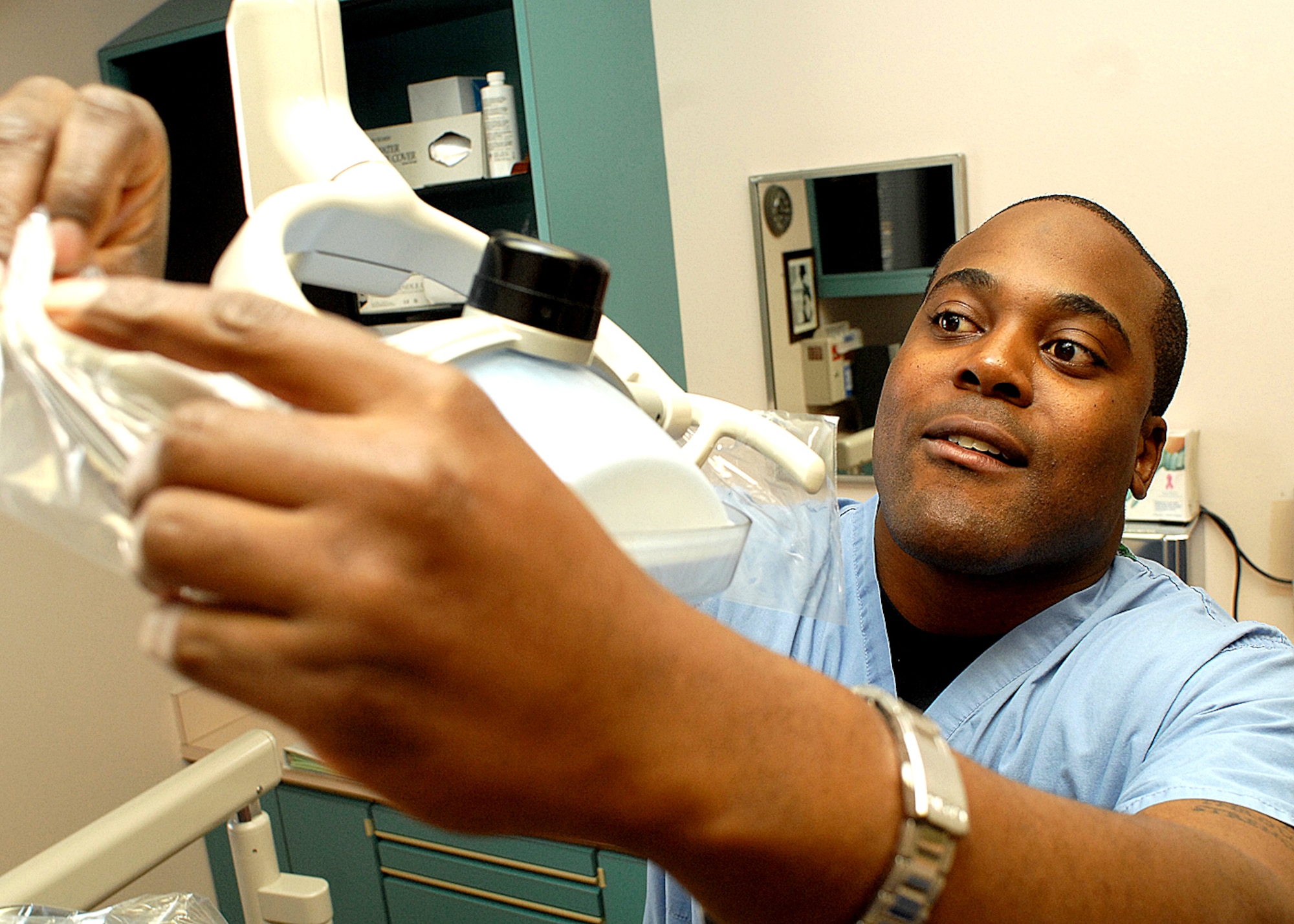 Senior Airman Stefan Elmore, a 377th Dental Squadron dental assistant, prepares a room for a patient in the dental clinic here. The American Dental Association Dental Assistants Appreciation Week runs from March 4-10. (U.S. Air Force photo by Todd Berenger)