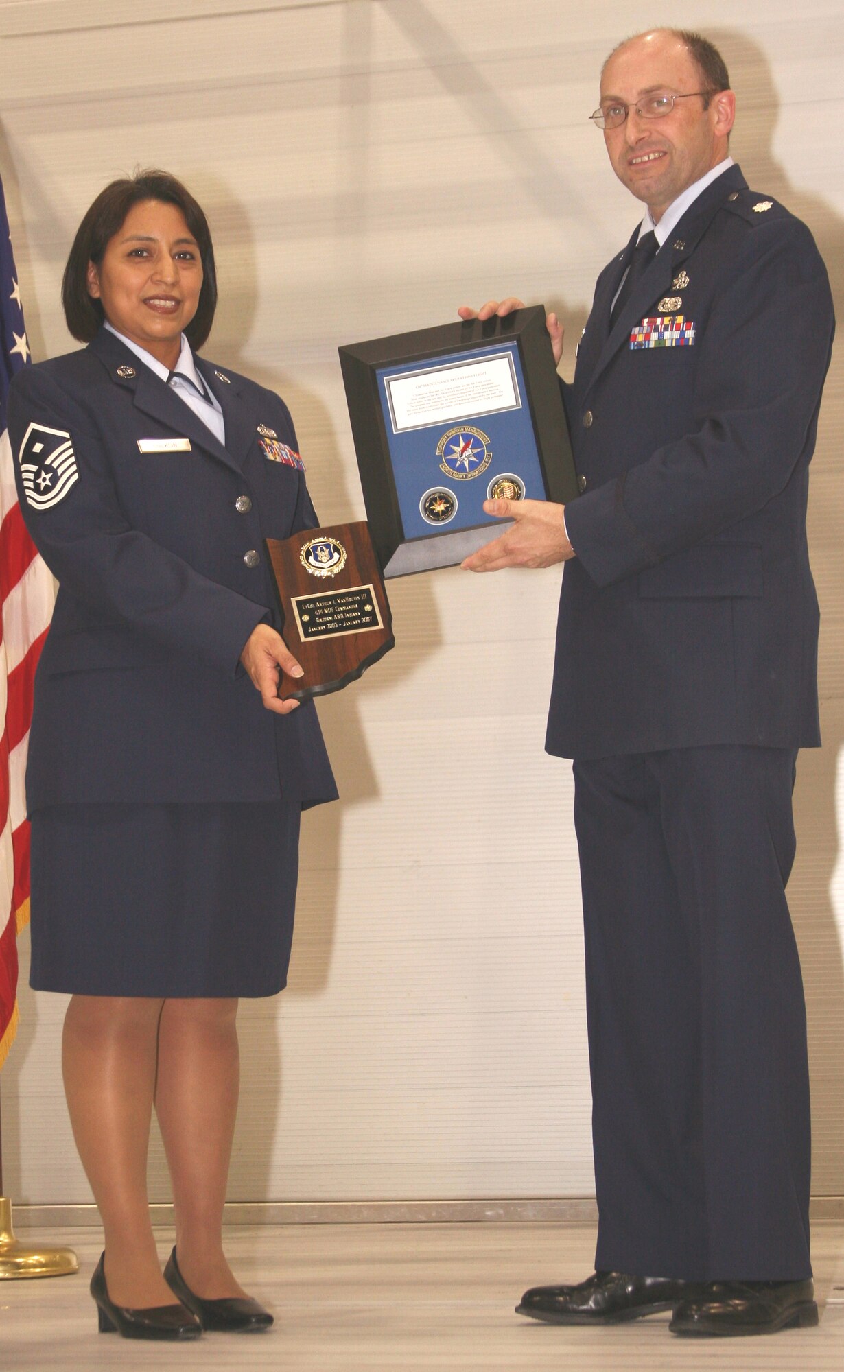GRISSOM AIR RESERVE BASE, Ind.-- Lt. Col. Arthur VanHouten, the outgoing commander of the 434th Maintenance Operations Flight, is presented parting gifts by Master Sgt. Martina Conklin, 434th MOF first sergeant, upon the change of command ceremony where he relenquished command of the unit to Maj. Michael Polomchak.  (U.S. Air Force photo/Senior Airman Omar Delacruz)
