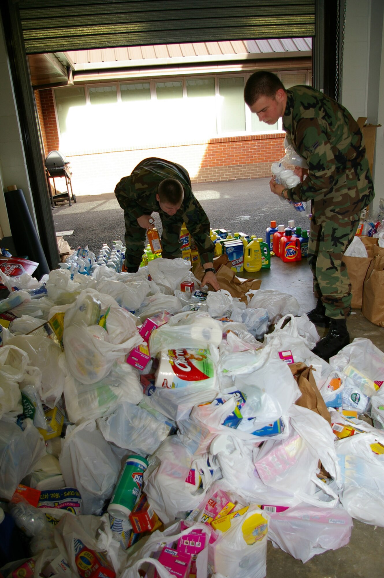 Airmen from the 100th Operations Support Squadron sort through donations from military members and their families donated March 3 and 4 at the RAF Lakenheath Commissary. Members from the 100th Operations Group's Galaxy Team 5/6 committee spent the weekend collecting items as part of the wounded soldier item drive. The items collected will be sent to the Fisher House at Landstuhl in Germany. More than 50 shopping carts-worth of goods were donated; including foil; dishwashing liquid; toilet rolls; paper plates and plastic cutlery; and packets of sugar. (U.S. Air Force photo by Karen Abeyasekere)