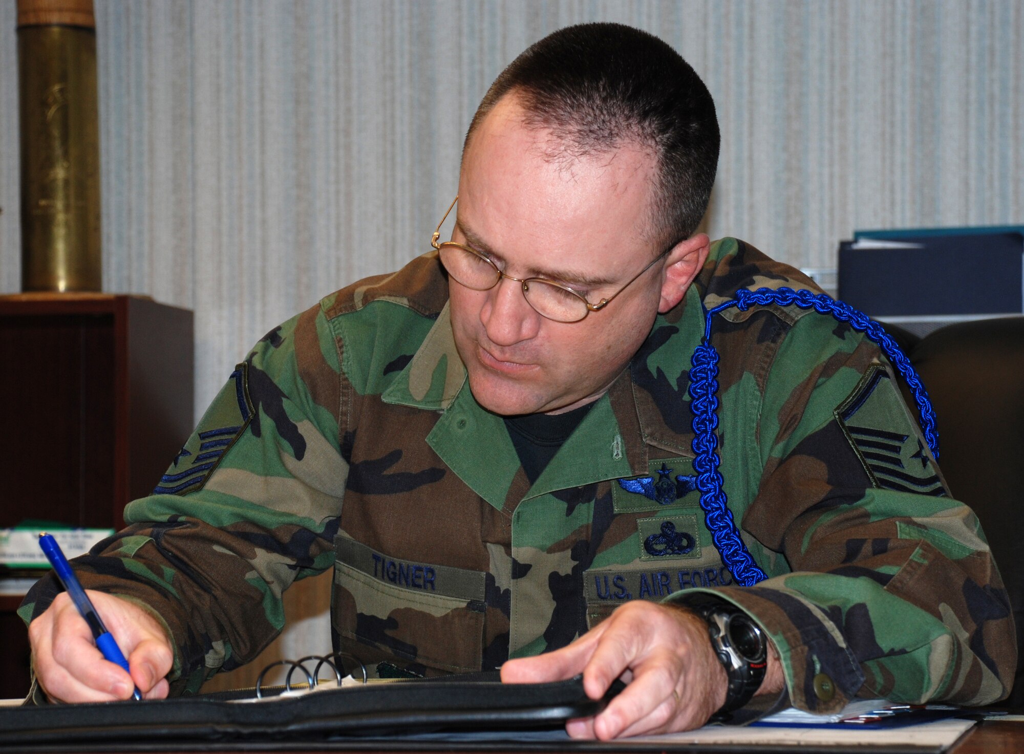 Master Sgt. Douglas Tigner, the 82nd Training Wing military training flight chief, checks his schedule to prepare for an ordinary duty day. On Feb. 21, Sergeant Tigner's day ended extraordinarily when he and Tech. Sgt. Norman D. Hicks III, a military training leader from the 360th Training Squadron, administered a shock from an Automated External Defibrillator and cadiopulmonary resuscitation on an Airman-in-Training during physical readiness training. (U.S. Air Force photo/Master Sgt. Jennifer Isom)